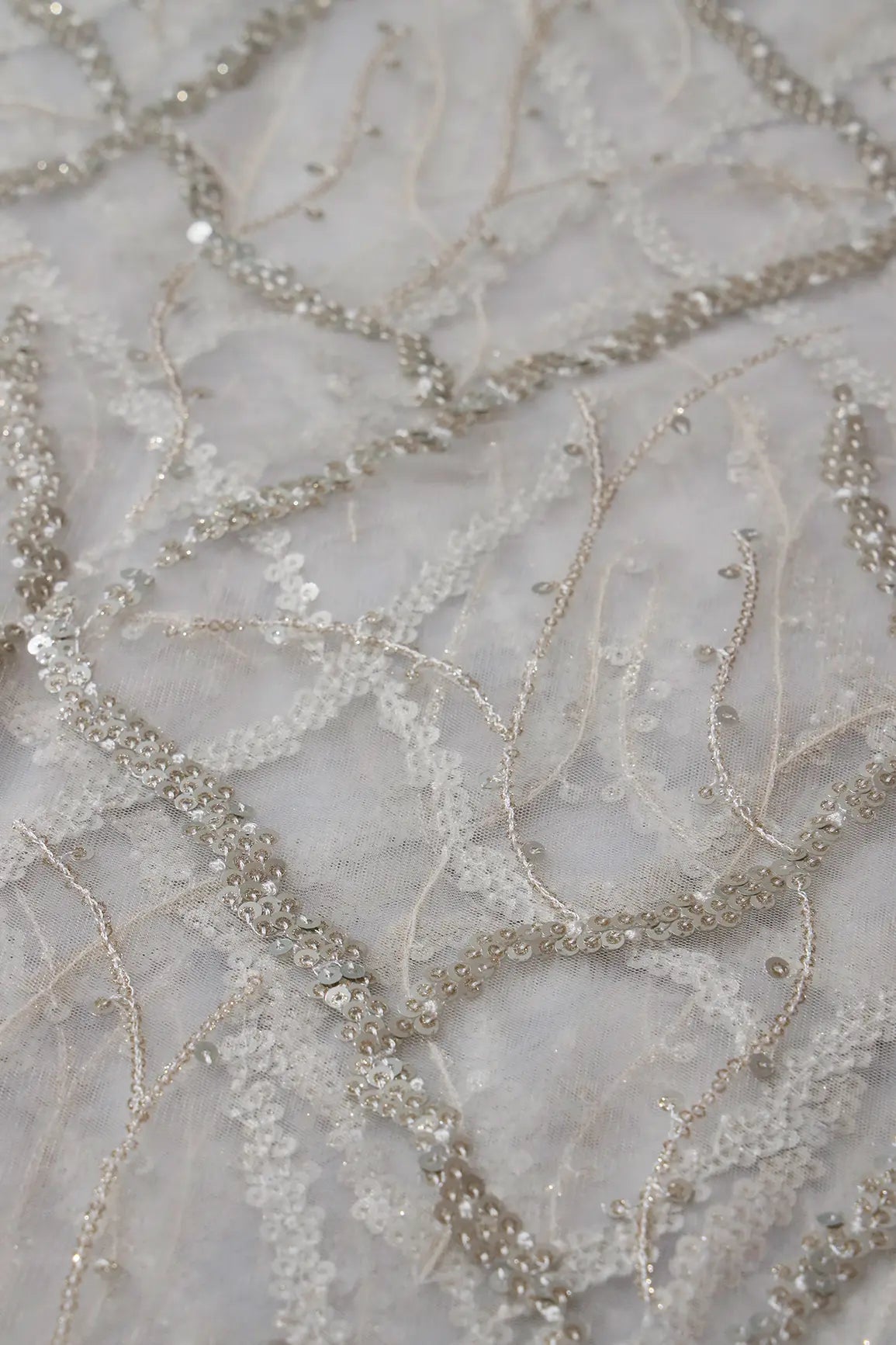 Silver Sequins Geometric Embroidery On White Dyeable Soft Net Fabric
