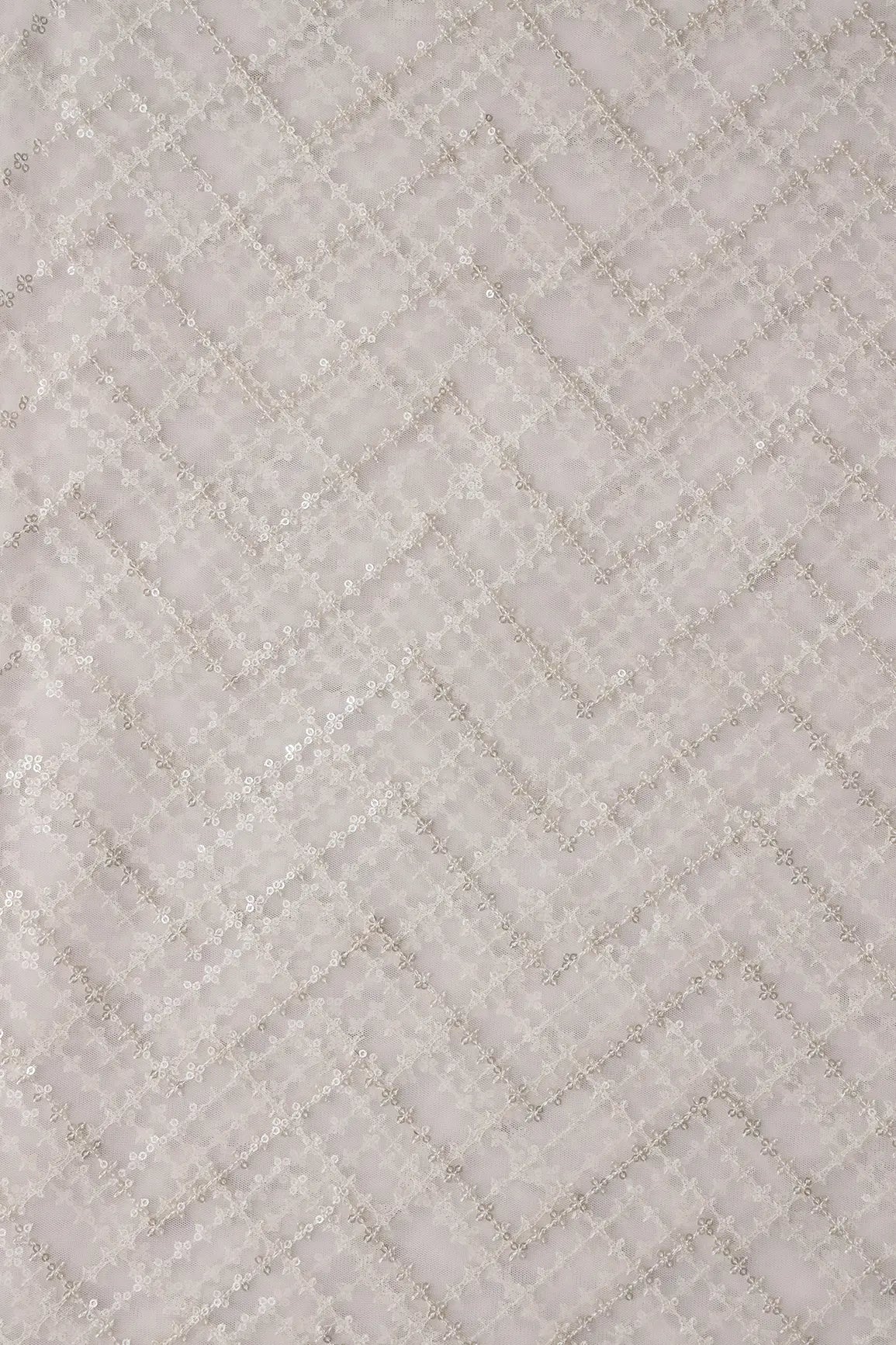 Silver Sequins Chevron Embroidery Work On White Dyeable Soft Net Fabric