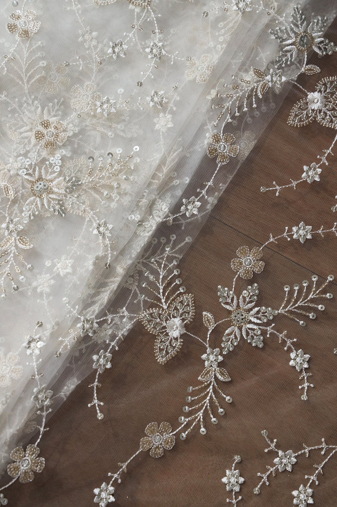 Beautiful White Thread With Sequins Floral Embroidery Work On White Dyeable Soft Net Fabric
