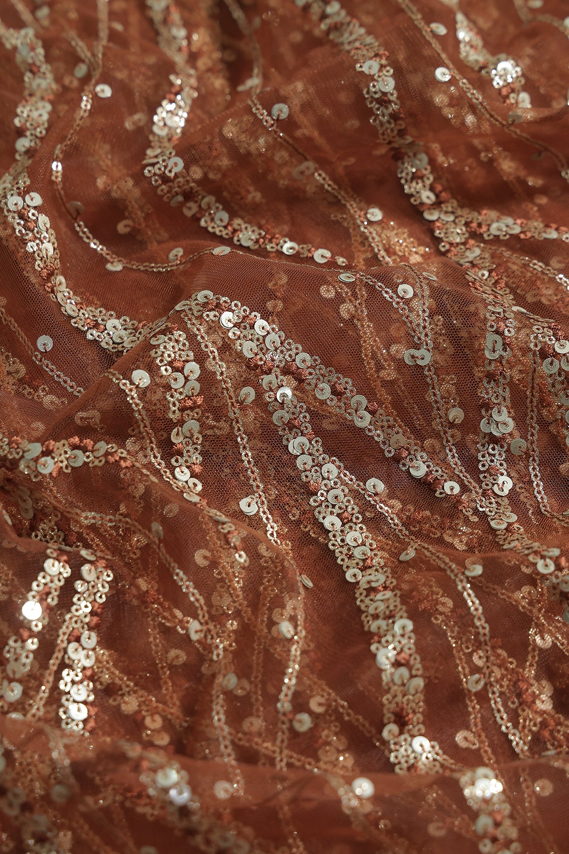 Gold And Silver Sequins With Brown Thread Wavy Embroidery Work On Brown Soft Net Fabric
