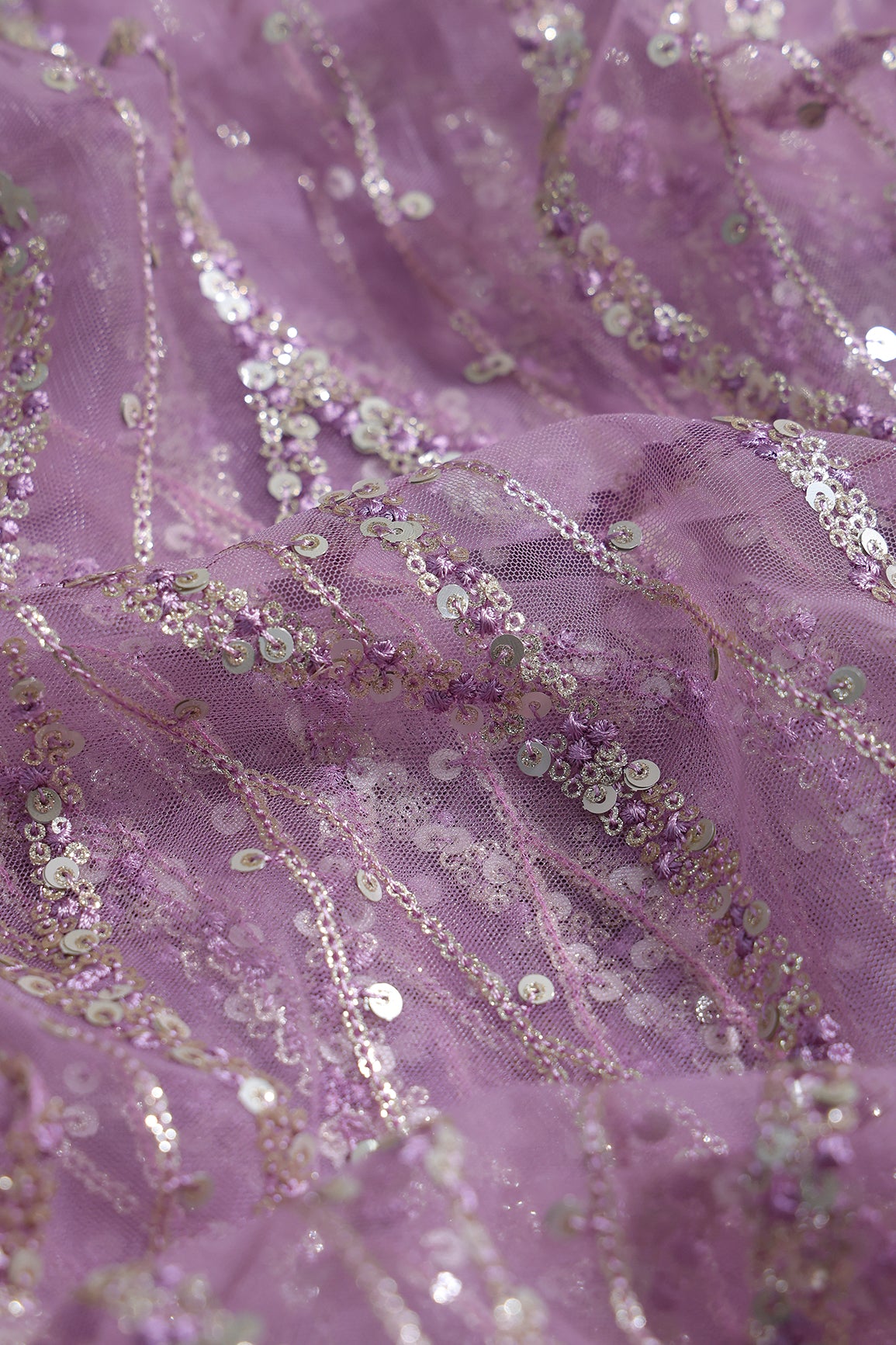 Gold And Silver Sequins With Lavender Thread Wavy Embroidery Work On Lavender Soft Net Fabric