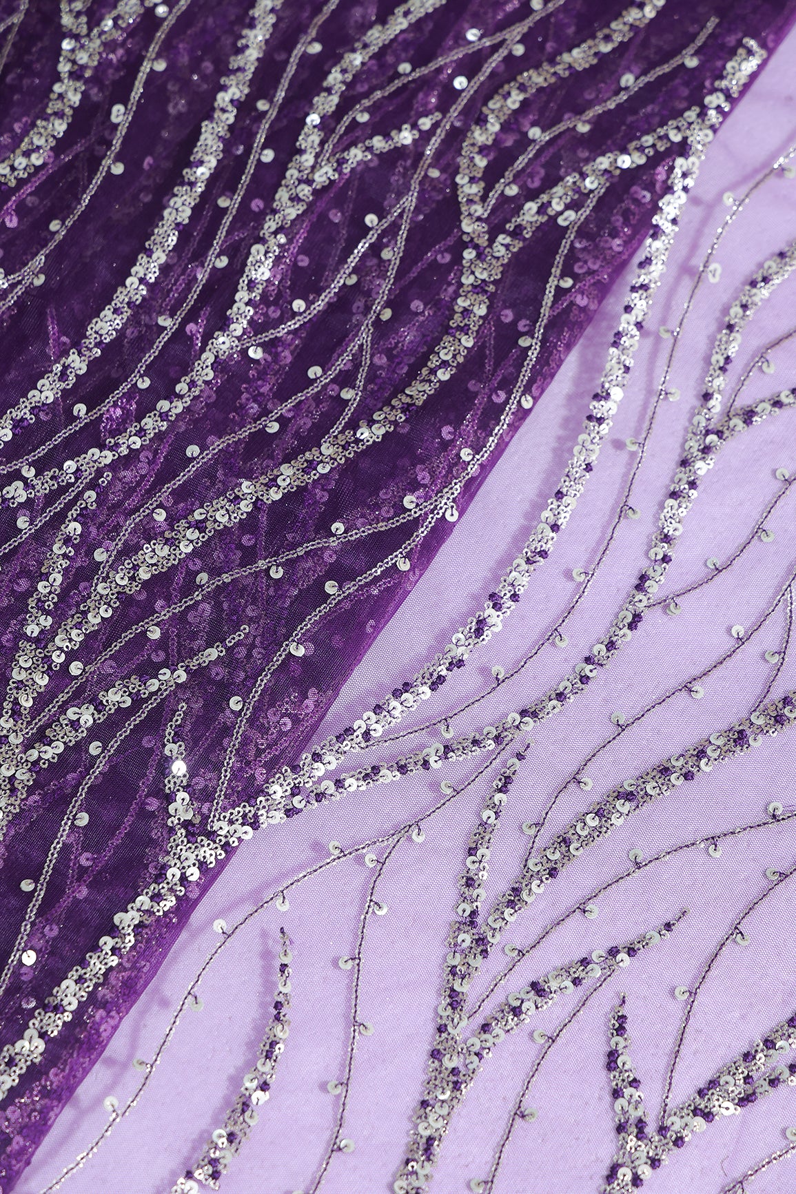 Gold And Silver Sequins With Purple Thread Wavy Embroidery Work On Purple Soft Net Fabric