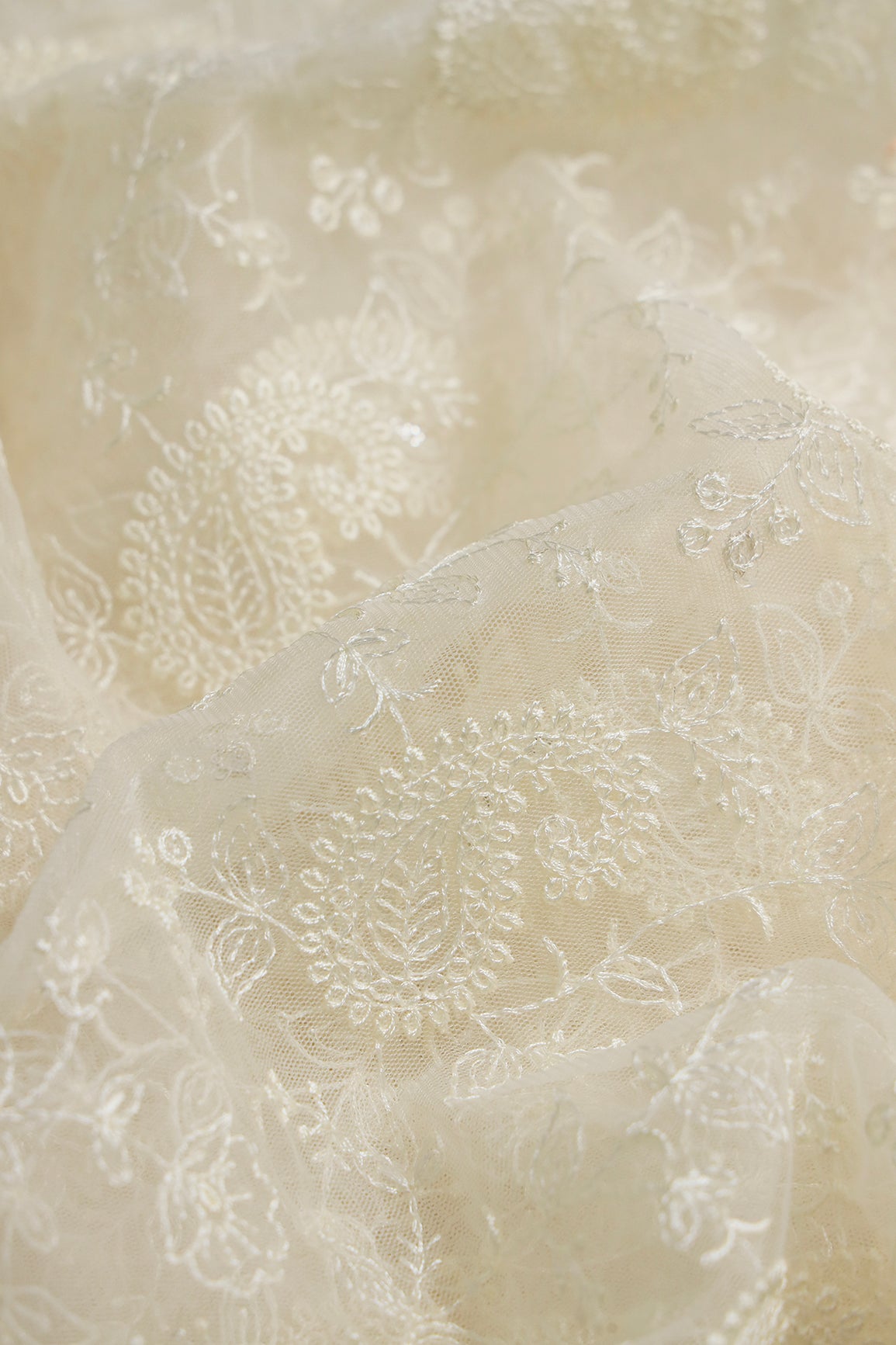 Cream Thread With Water Sequins Floral Paisley Embroidery Work On Cream Soft Net Fabric