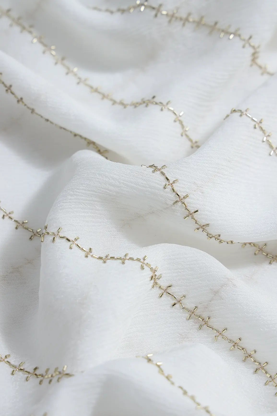Gold Beads Cut Dana Stripes Embroidery Work On Dyeable White Chinnon Chiffon Fabric