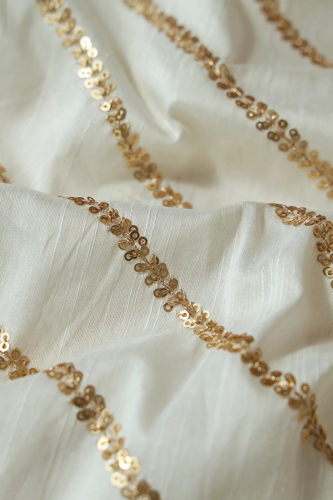 Gold Sequins With Gold Zari Stripes Embroidery Work On White Raw Silk Fabric