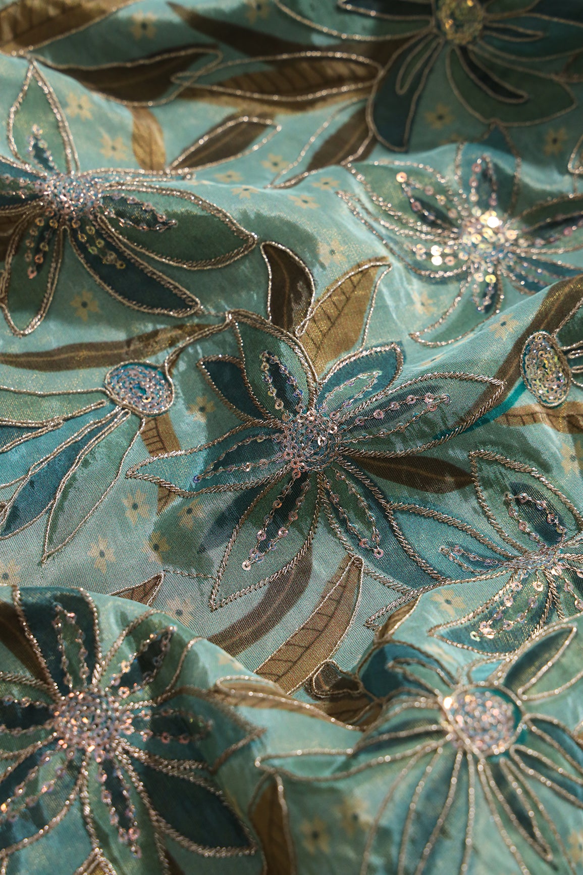 Floral Position Print On Sequins With Zari Embroidery On Pastel Olive Viscose Zari Tissue Fabric