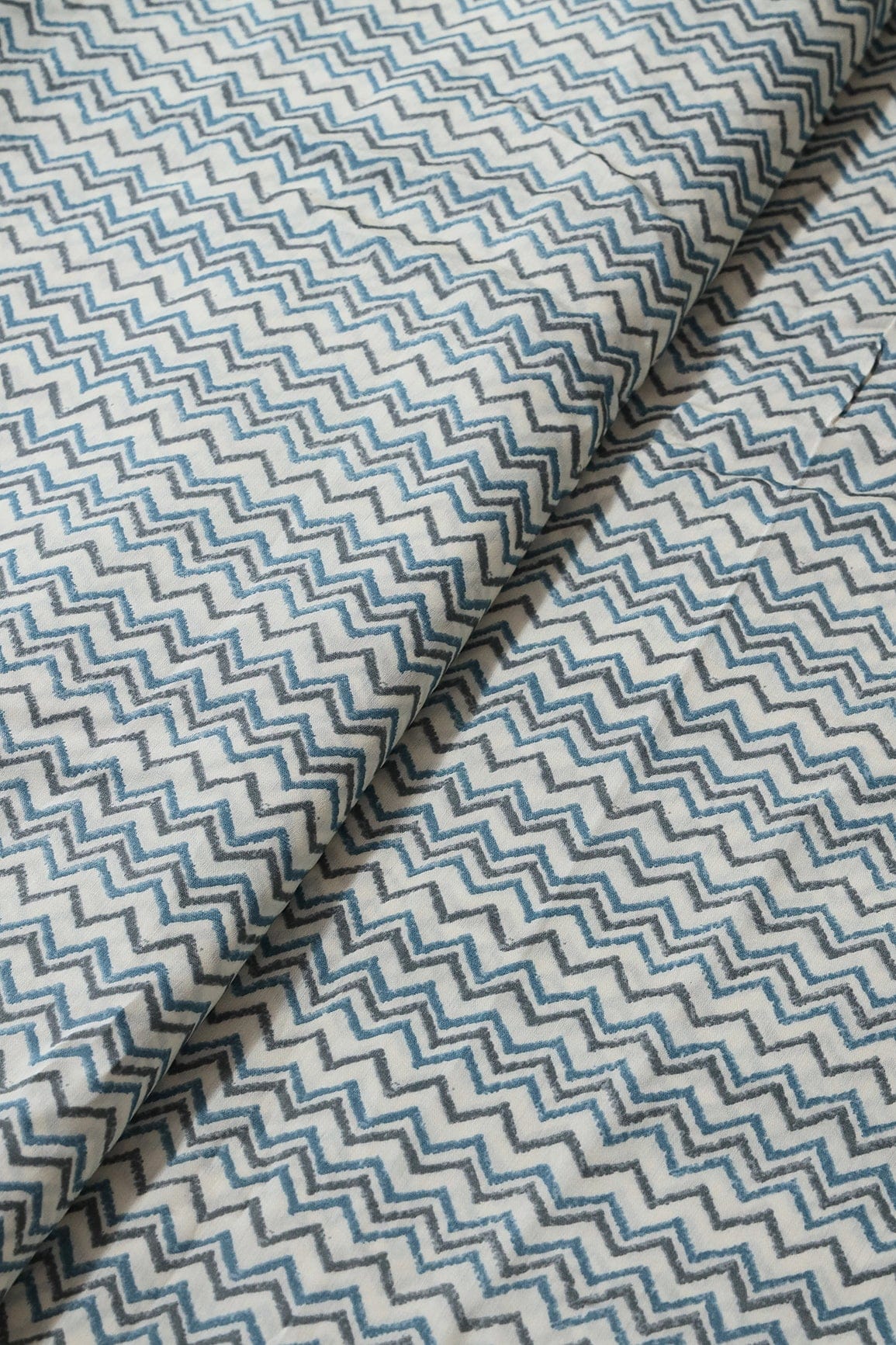 Azzure Blue And Grey Chevron Print On Cream Viscose Chanderi Silk Fabric - doeraa
