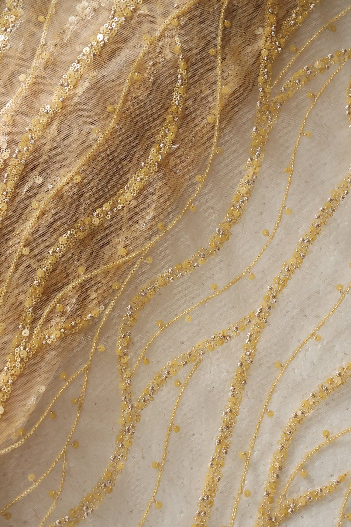 Beautiful Sequins With Beige Thread Wavy Embroidery Work On Beige Soft Net Fabric - doeraa