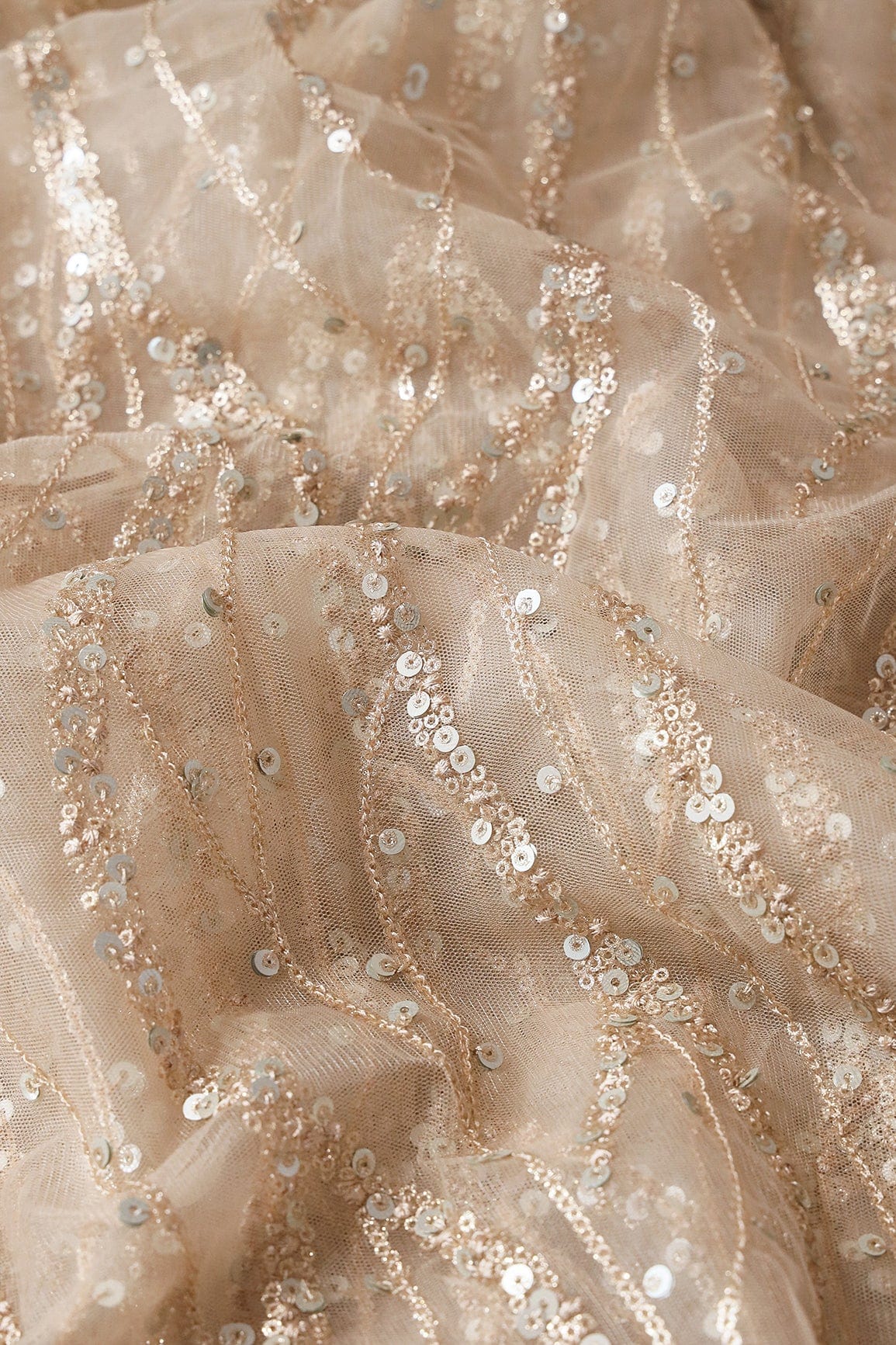 Gold And Silver Sequins With Beige Thread Wavy Embroidery On Light Beige Soft Net - doeraa