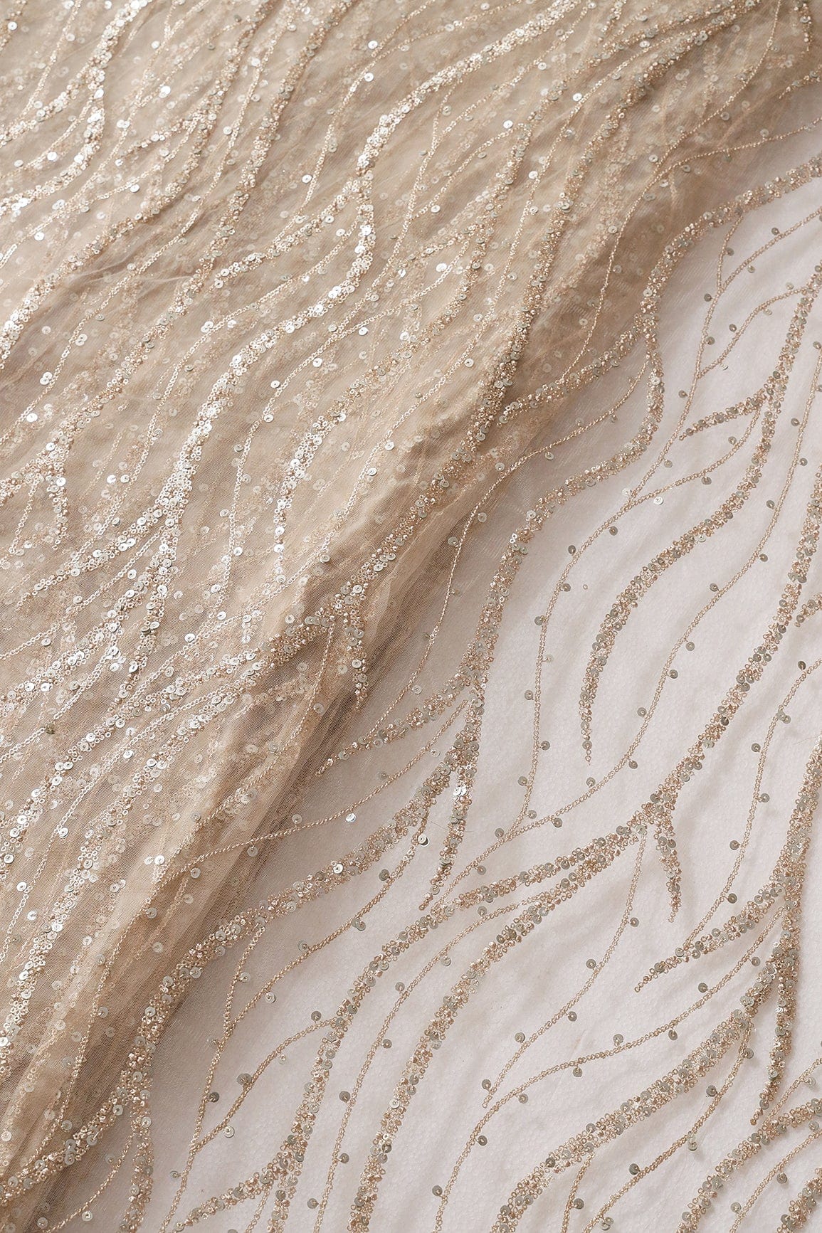 Gold And Silver Sequins With Beige Thread Wavy Embroidery On Light Beige Soft Net - doeraa