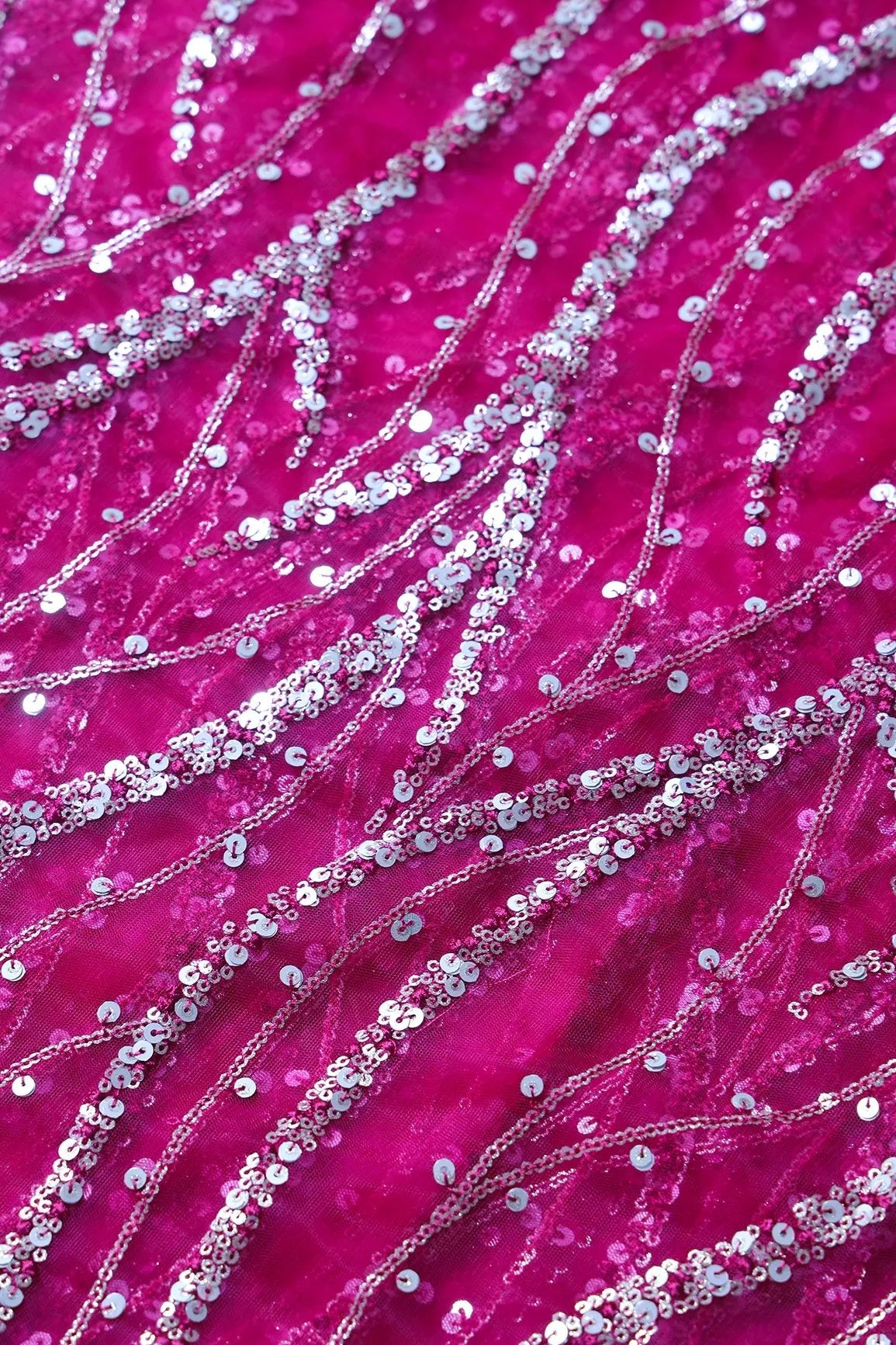 Gold And Silver Sequins With Fuchsia Thread Wavy Embroidery Work On Fuchsia Soft Net Fabric - doeraa