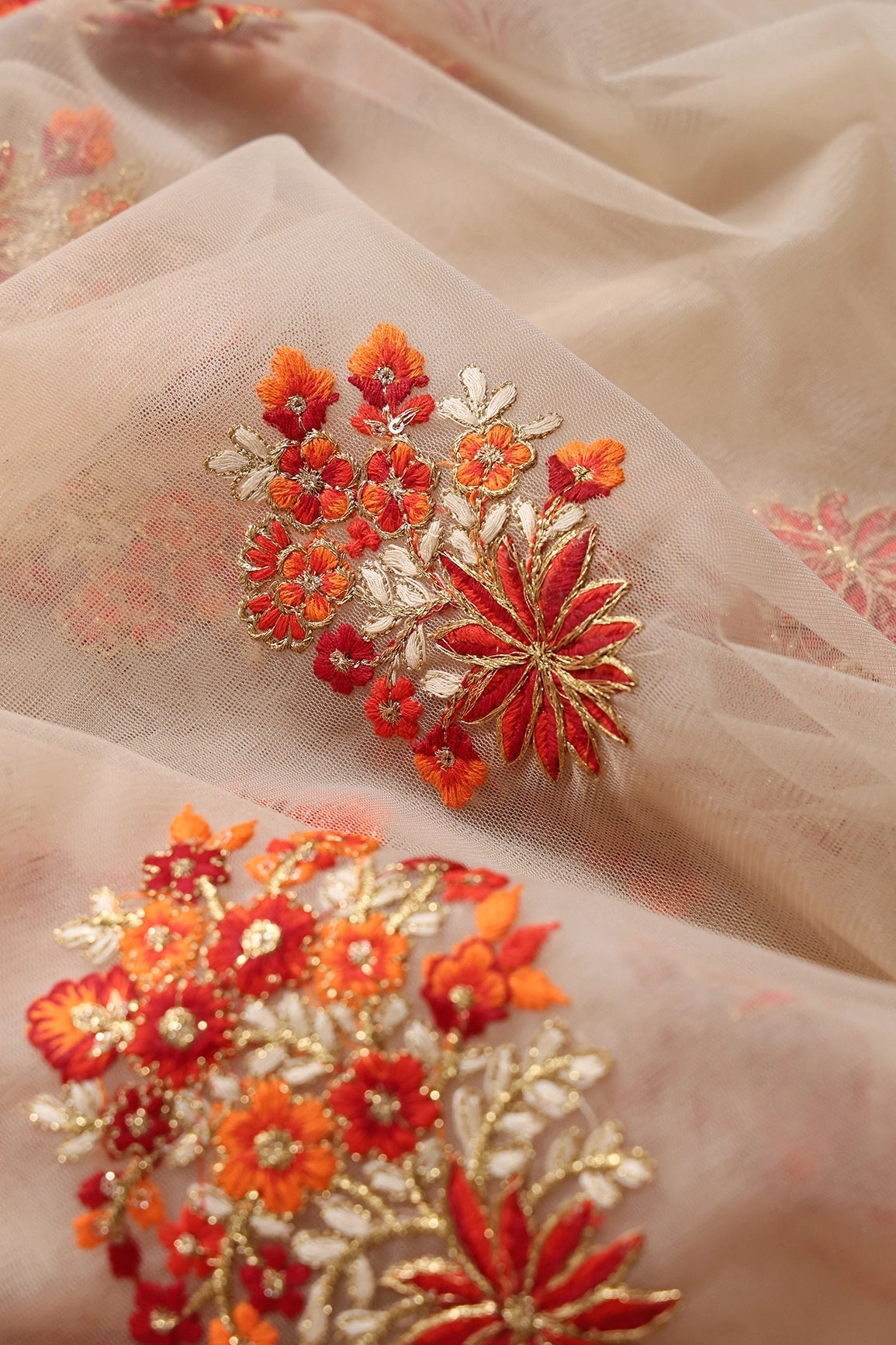 Orange And Beige Thread With Gold Zari Floral Butta Embroidery On Beige Soft Net Fabric - doeraa