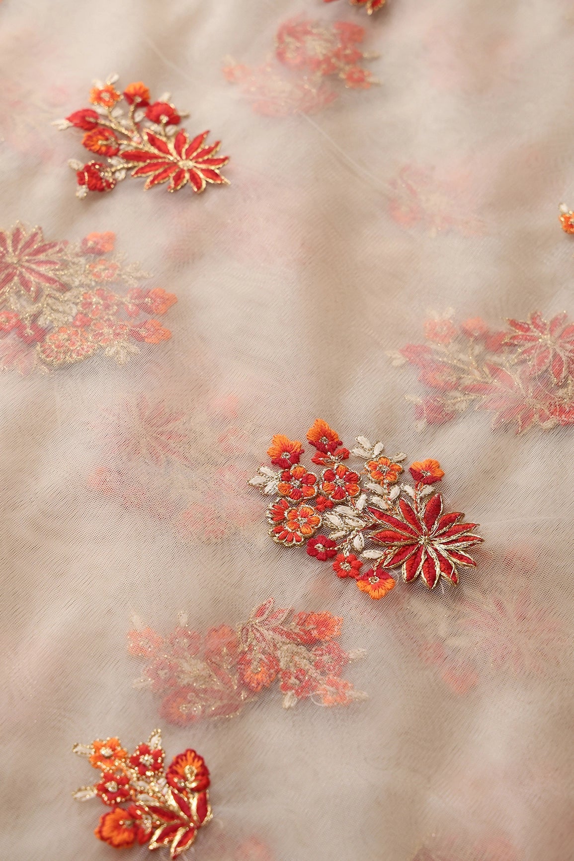 Orange And Beige Thread With Gold Zari Floral Butta Embroidery On Beige Soft Net Fabric - doeraa