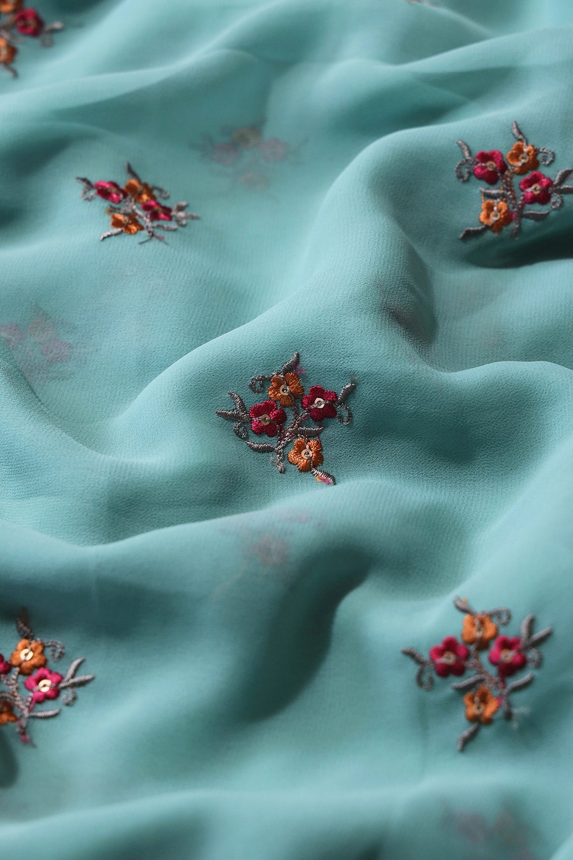 Orange And Dark Pink Thread With Sequins Floral Embroidery Work On Teal Georgette Fabric - doeraa