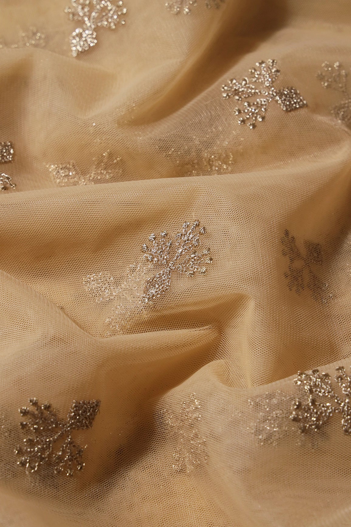 Small Gold Glitter Sequins With Zari Floral Embroidery On Beige Soft Net Fabric - doeraa