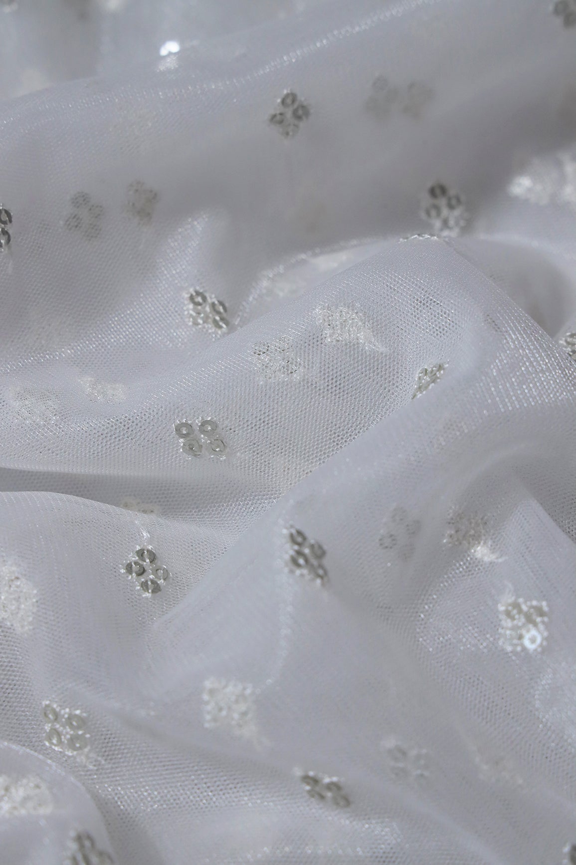 Small Motif Sequins Embroidery Work On White Dyeable Soft Net Fabric - doeraa