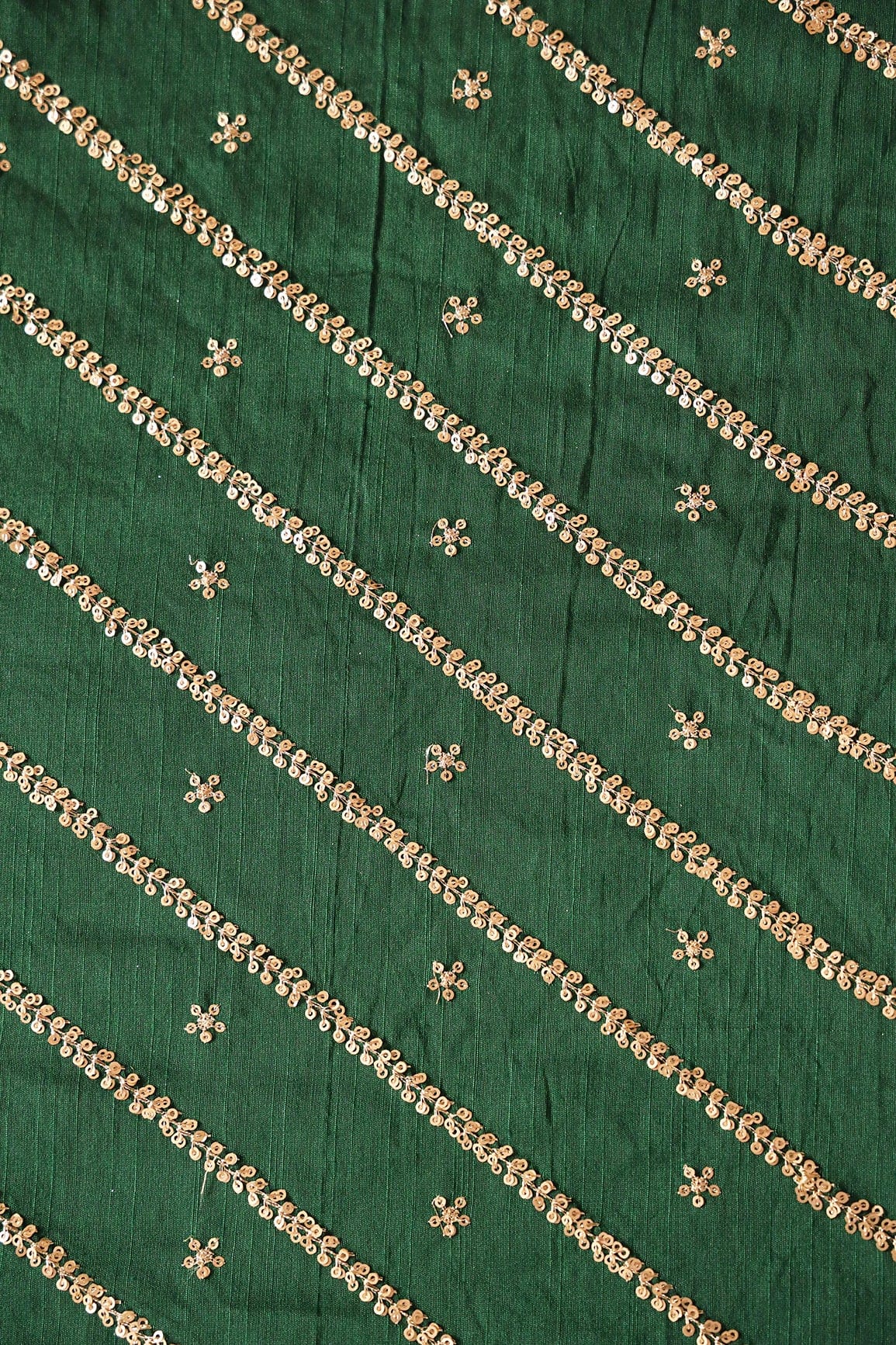 Gold Sequins With Gold Zari Stripes And Small Motif Embroidery Work On Bottle Green Raw Silk Fabric - doeraa