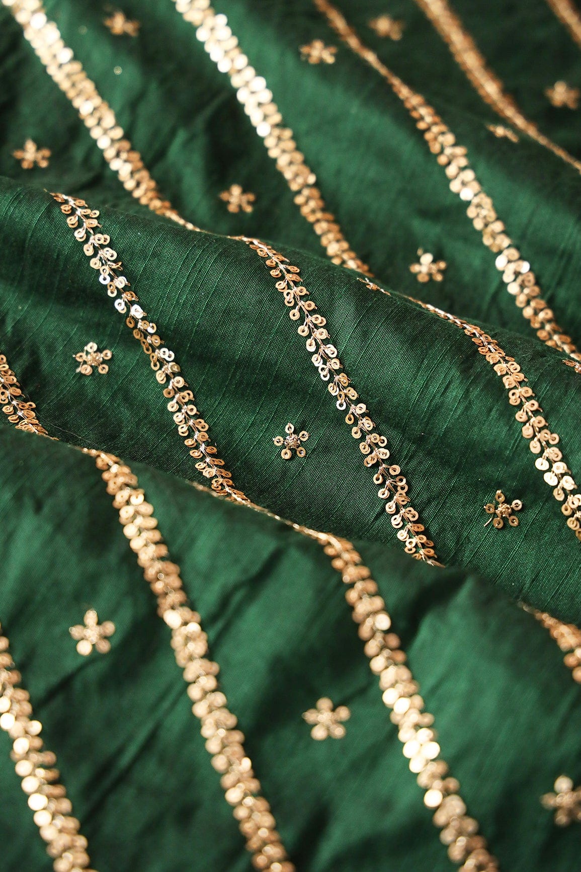 Gold Sequins With Gold Zari Stripes And Small Motif Embroidery Work On Bottle Green Raw Silk Fabric - doeraa