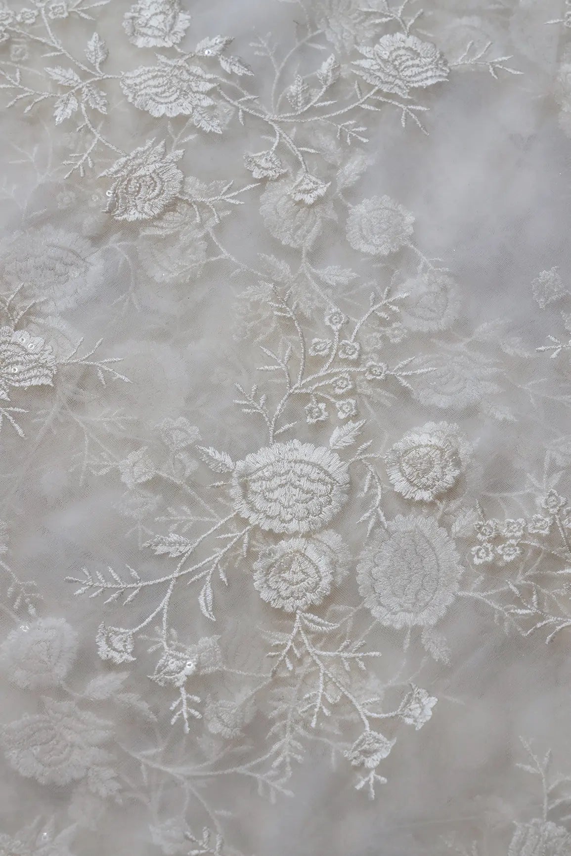 White Thread With Sequins Floral Embroidery On White Dyeable Soft Net Fabric