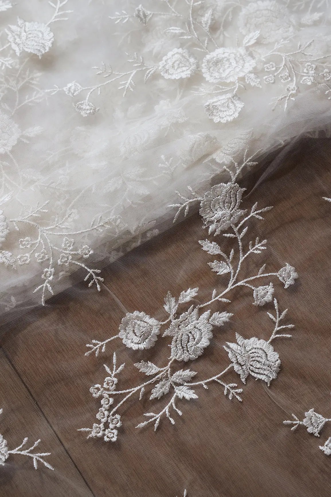 White Thread With Sequins Floral Embroidery On White Dyeable Soft Net Fabric