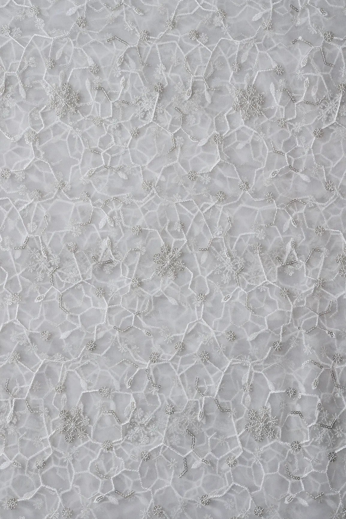 Beautiful Silver Sequins Small Floral Embroidery On White Dyeable Soft Net Fabric