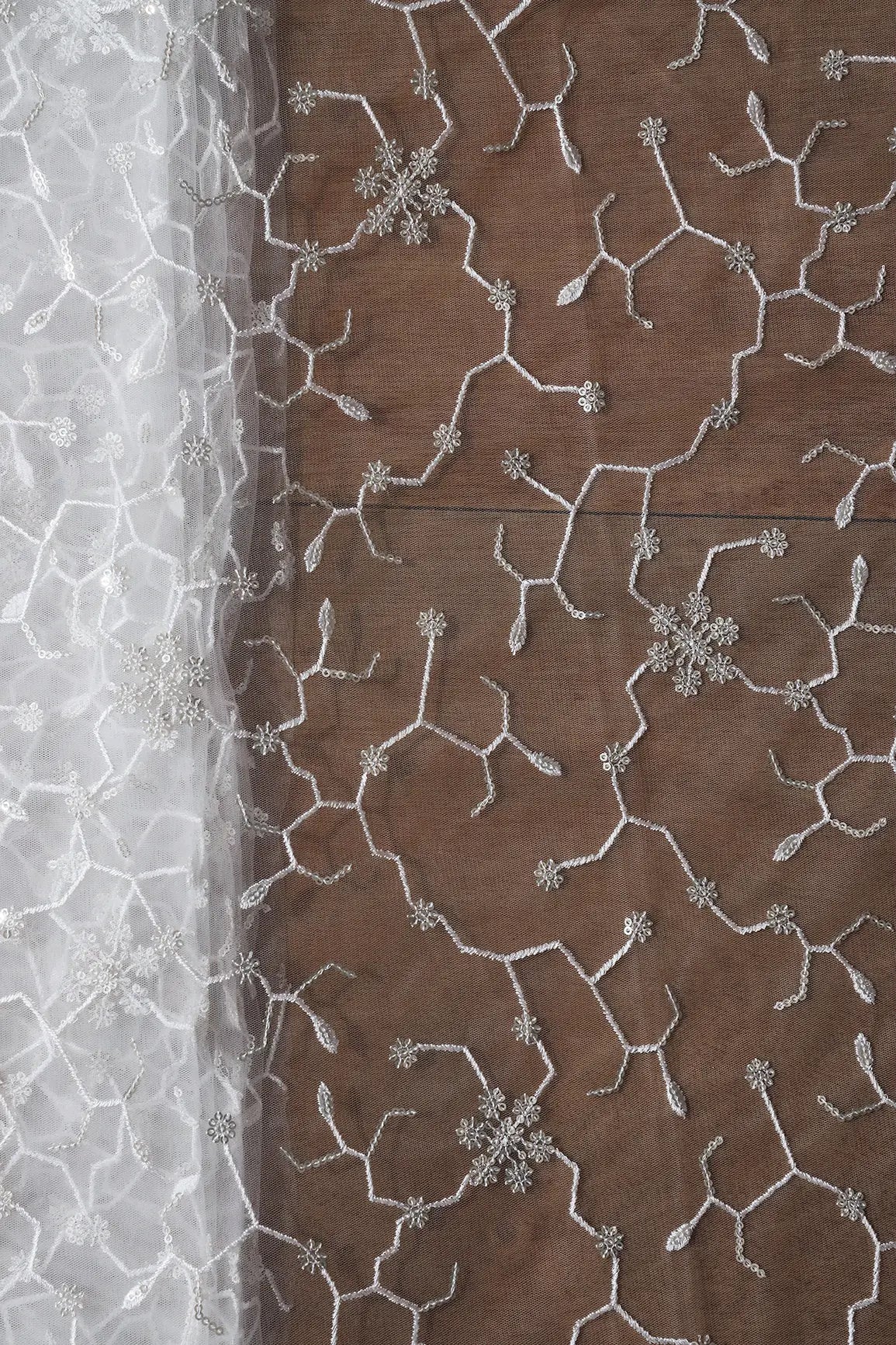 Beautiful Silver Sequins Small Floral Embroidery On White Dyeable Soft Net Fabric