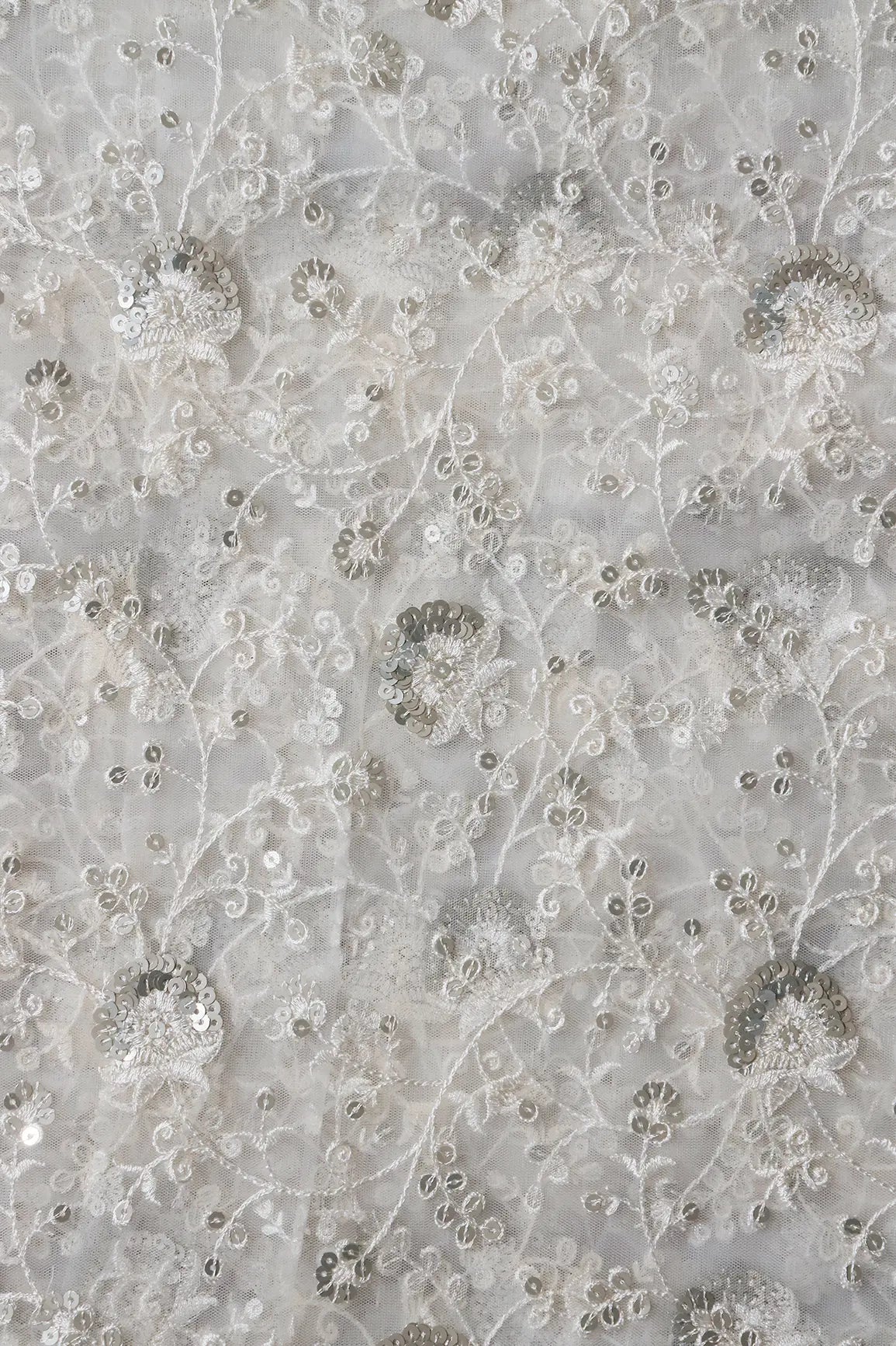 White Thread With Silver Sequins Floral Embroidery On White Dyeable Soft Net Fabric