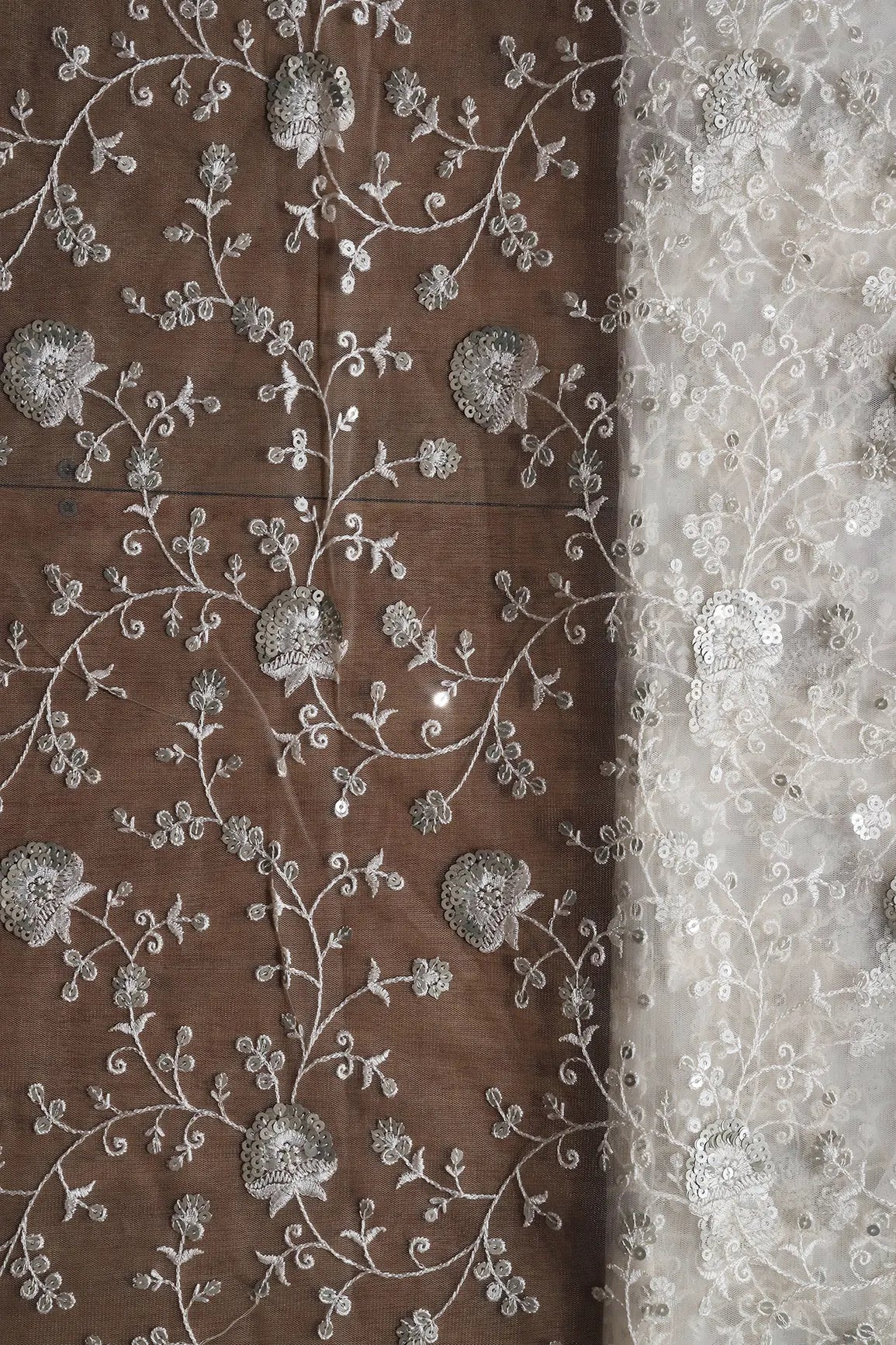 White Thread With Silver Sequins Floral Embroidery On White Dyeable Soft Net Fabric