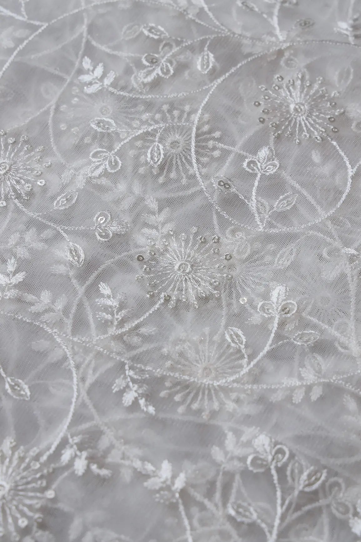 Silver Sequins With White Thread Floral Embroidery On White Dyeable Soft Net Fabric