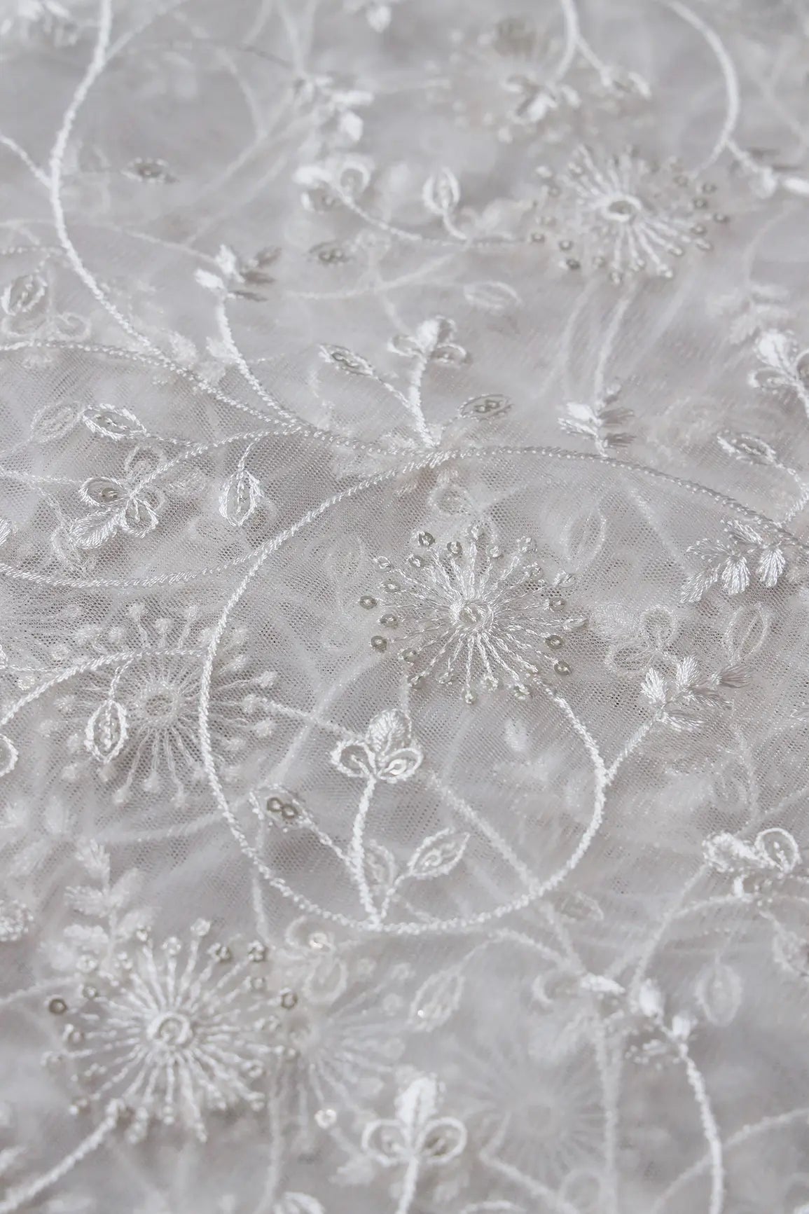 Silver Sequins With White Thread Floral Embroidery On White Dyeable Soft Net Fabric