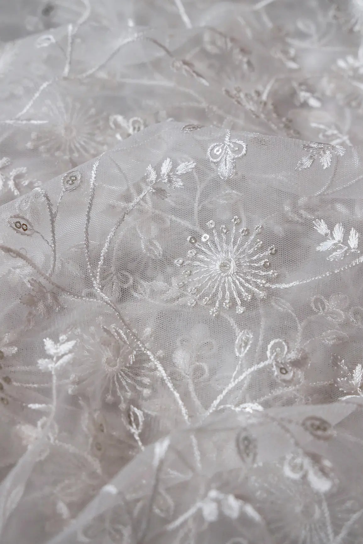 Silver Sequins With White Thread Floral Embroidery On White Dyeable Soft Net Fabric