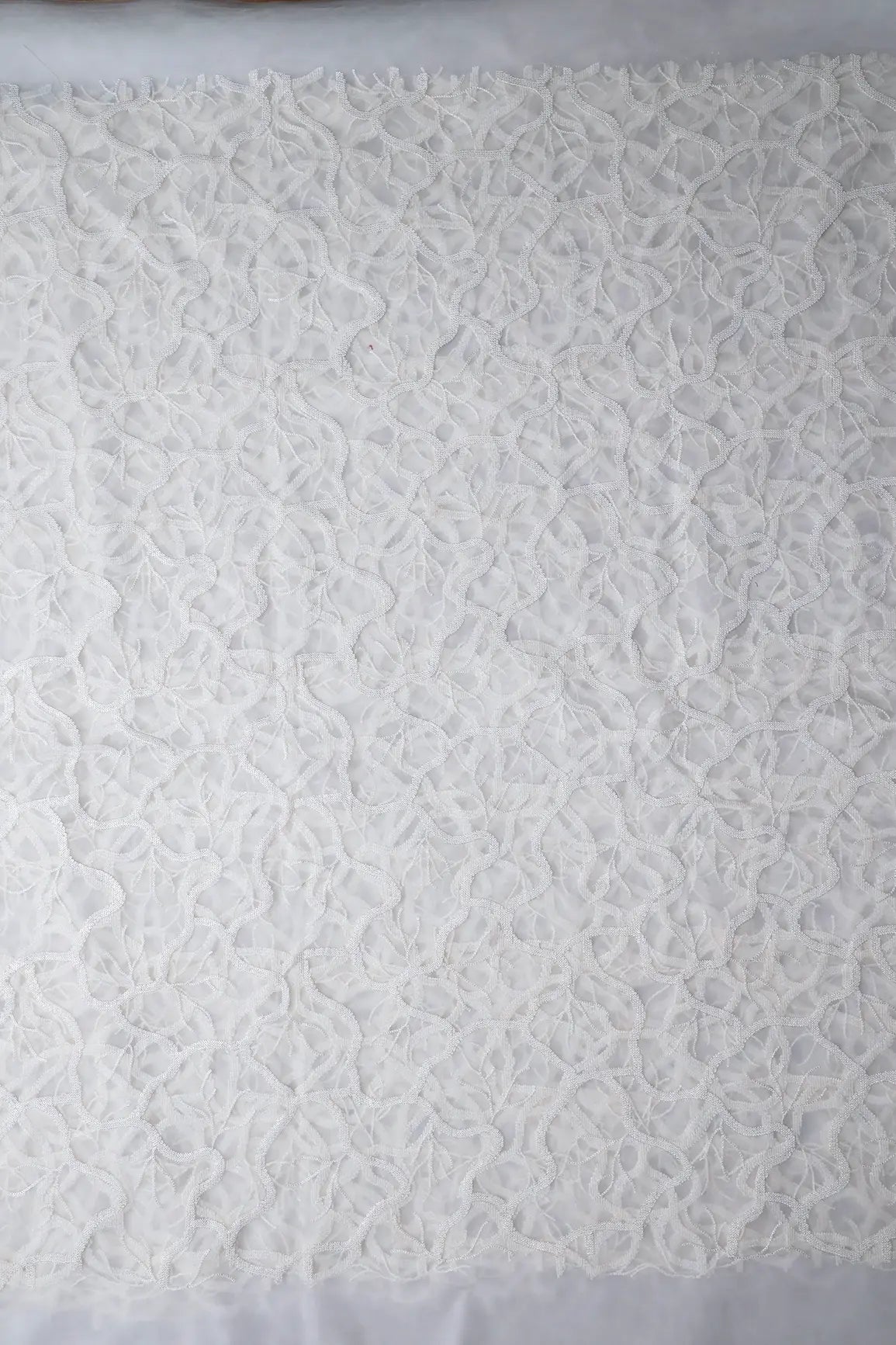 White Sequins Abstract Embroidery On White Dyeable Soft Net Fabric