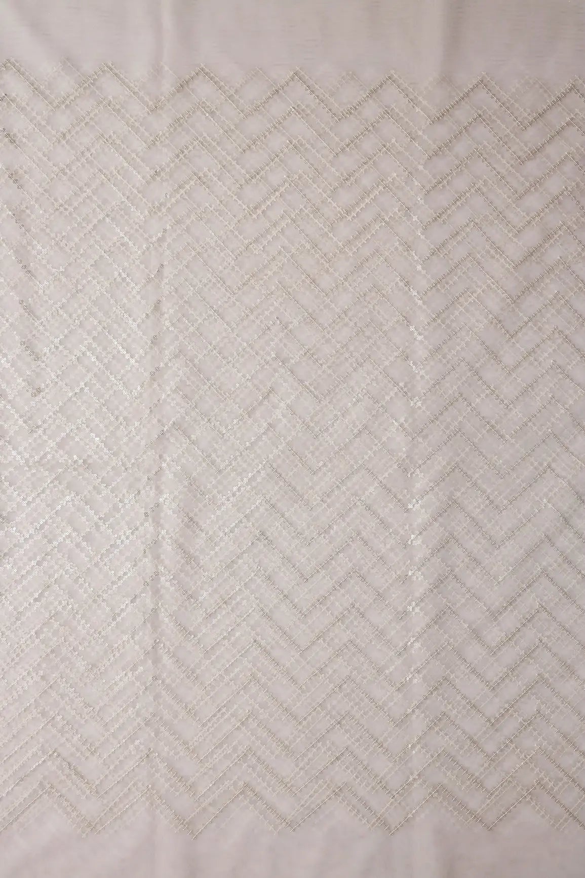 Silver Sequins Chevron Embroidery Work On White Dyeable Soft Net Fabric