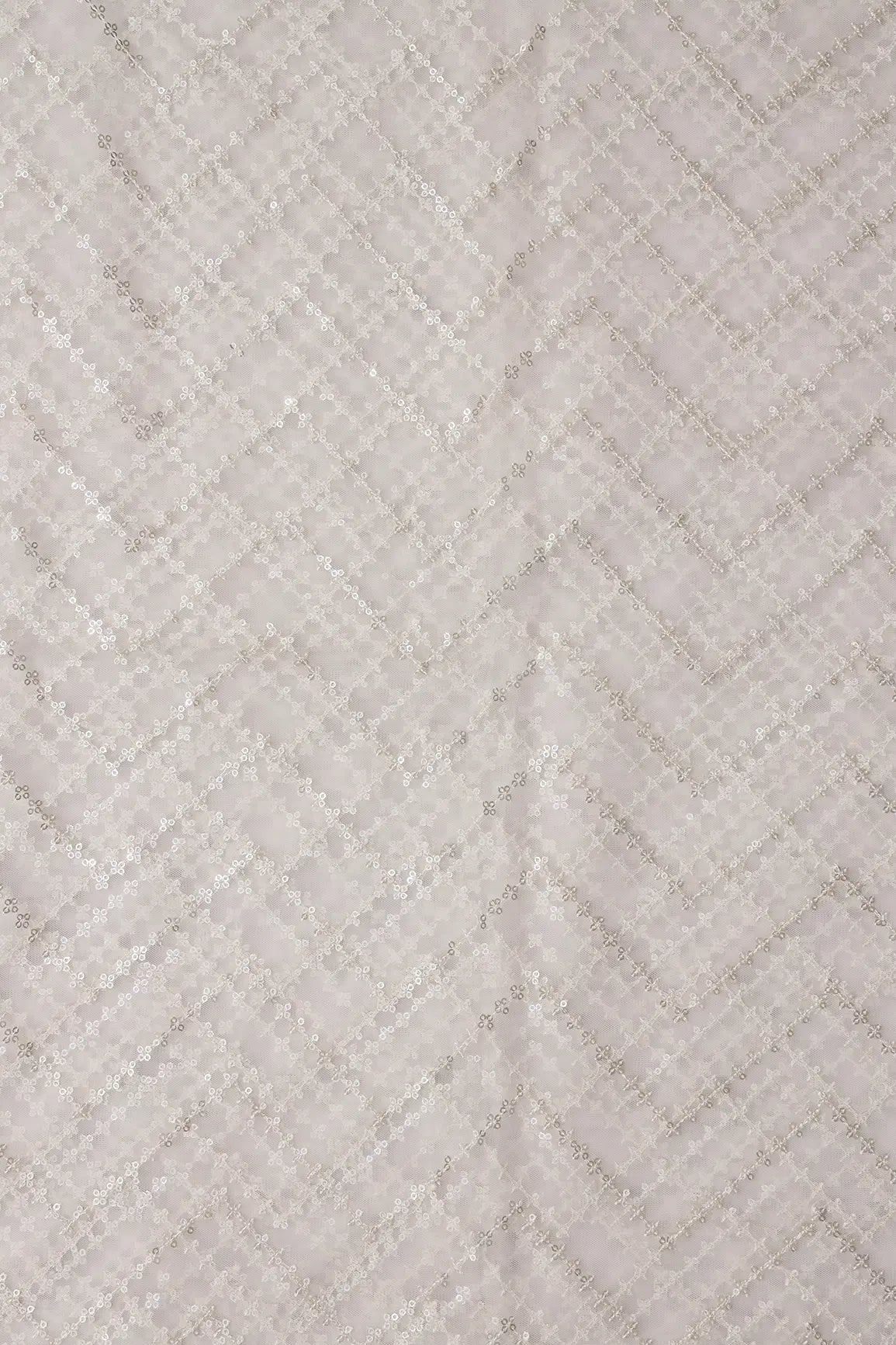 Silver Sequins Chevron Embroidery Work On White Dyeable Soft Net Fabric