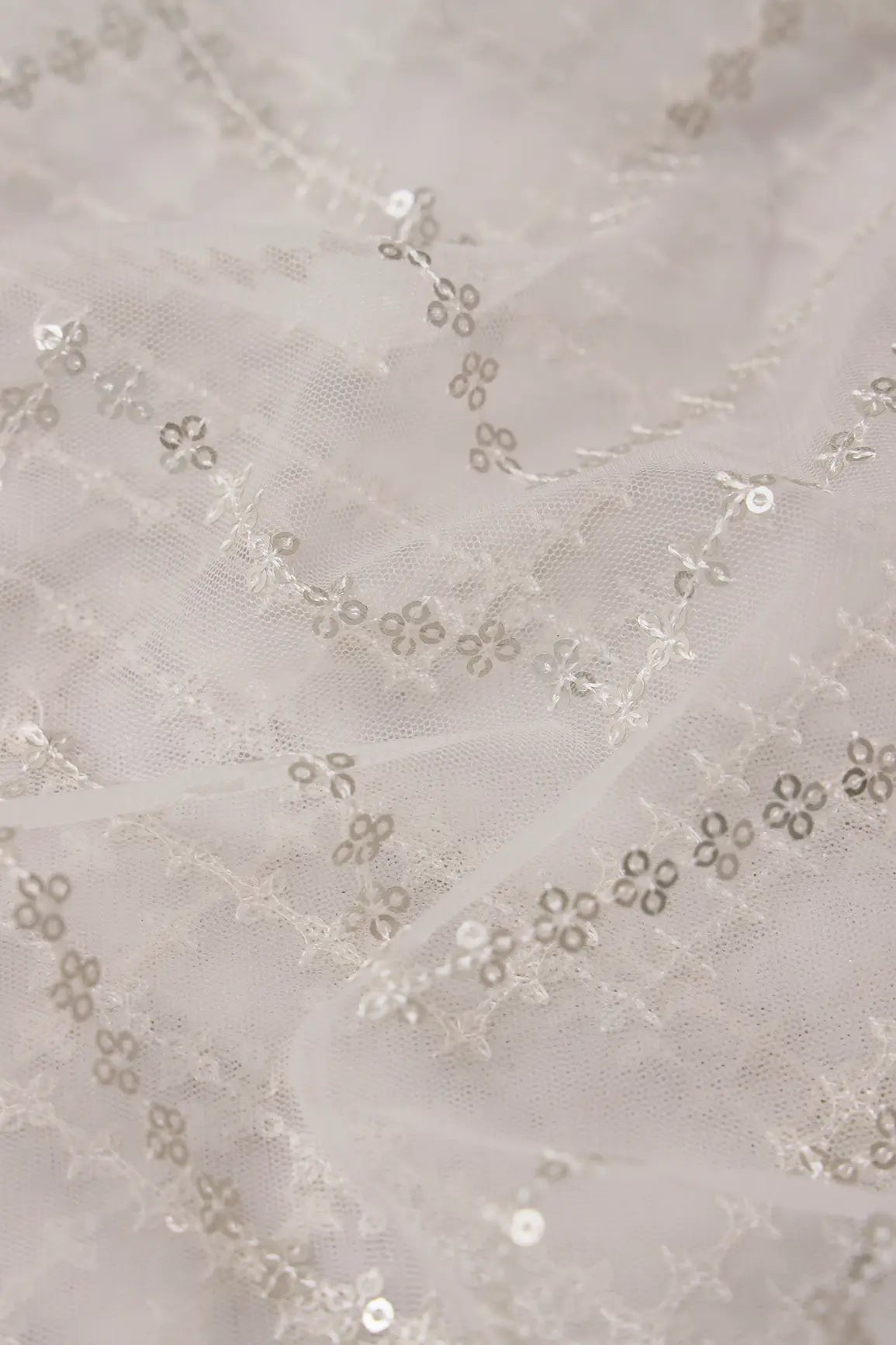 Silver Sequins Chevron Embroidery Work On White Dyeable Soft Net Fabric