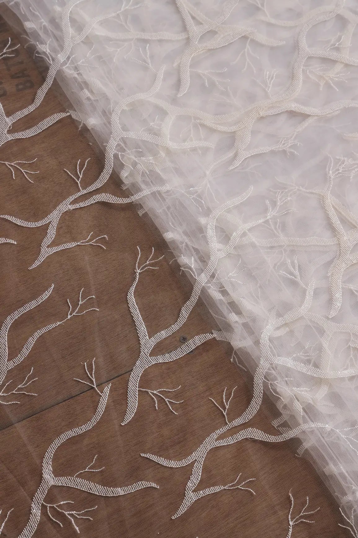 White Thread With Water Sequins Abstract Embroidery Work On Dyeable White Soft Net Fabric