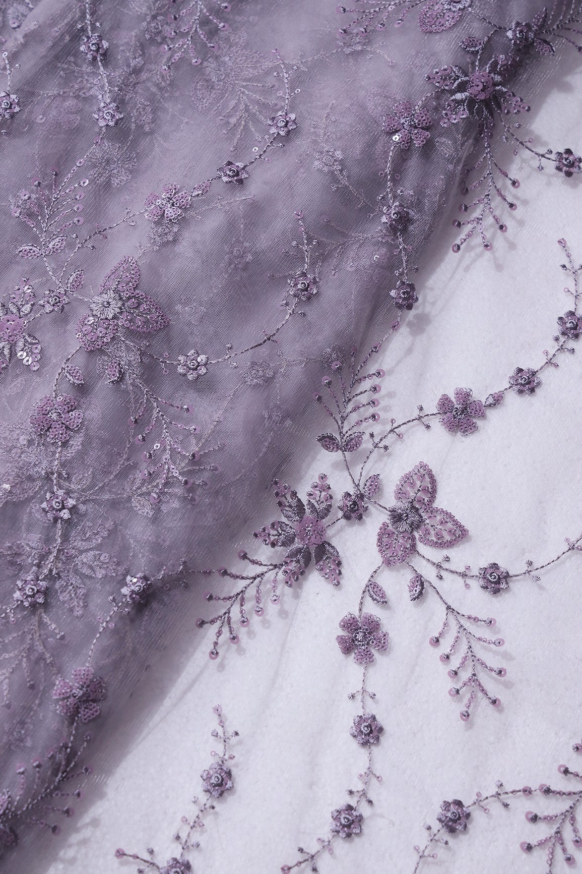 Beautiful Grey Thread With Sequins Floral Embroidery Work On Purple Grey Soft Net Fabric