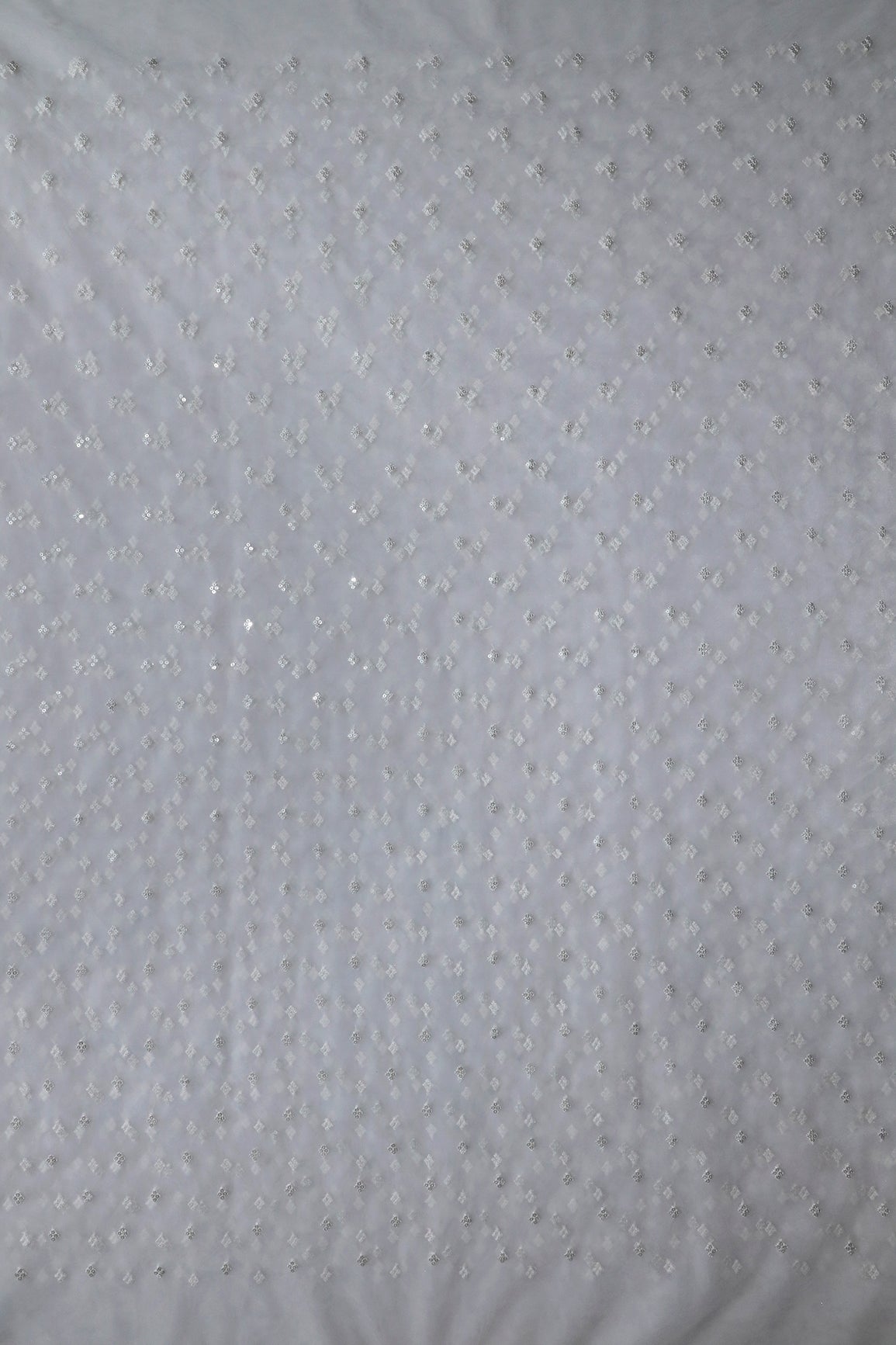 Small Motif Sequins Embroidery Work On White Dyeable Soft Net Fabric