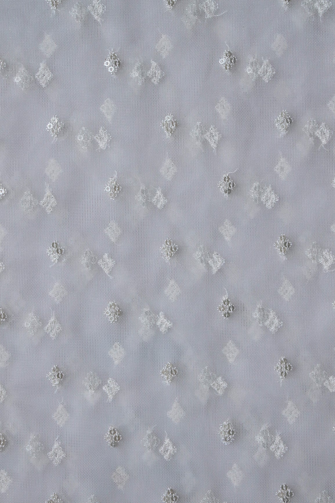 Small Motif Sequins Embroidery Work On White Dyeable Soft Net Fabric