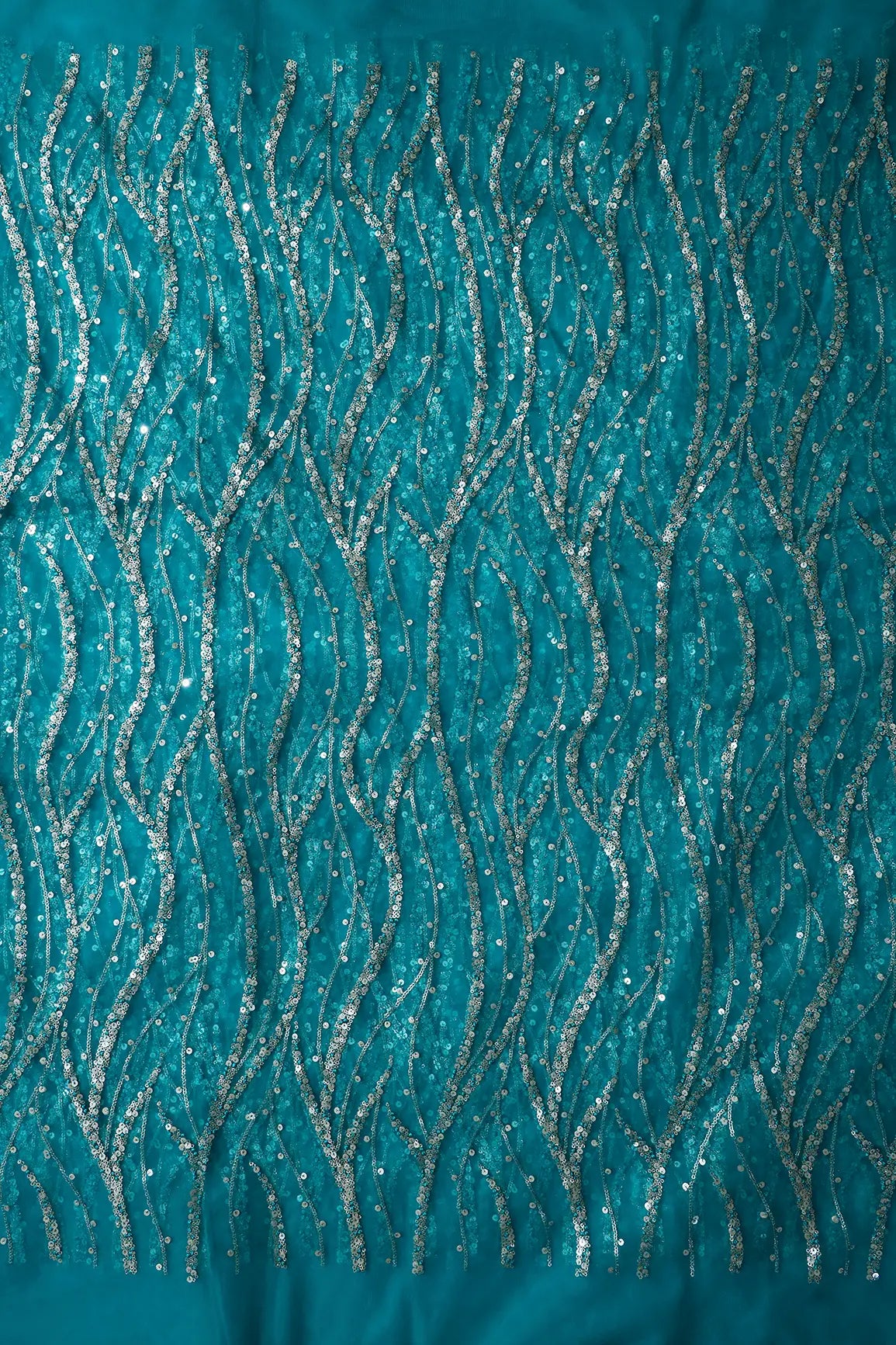 Gold And Silver Sequins With Peacock Blue Thread Wavy Embroidery On Peacock Blue Soft Net Fabric