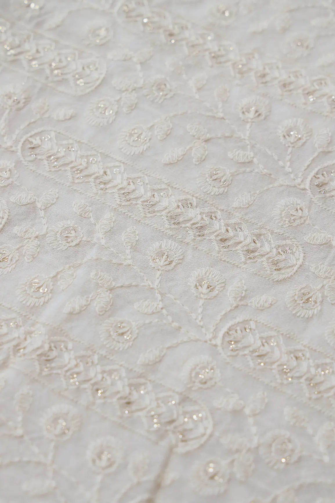 White Thread With Gold Glitter Sequins Floral Lucknowi Embroidery On Dyeable Viscose Georgette Fabric