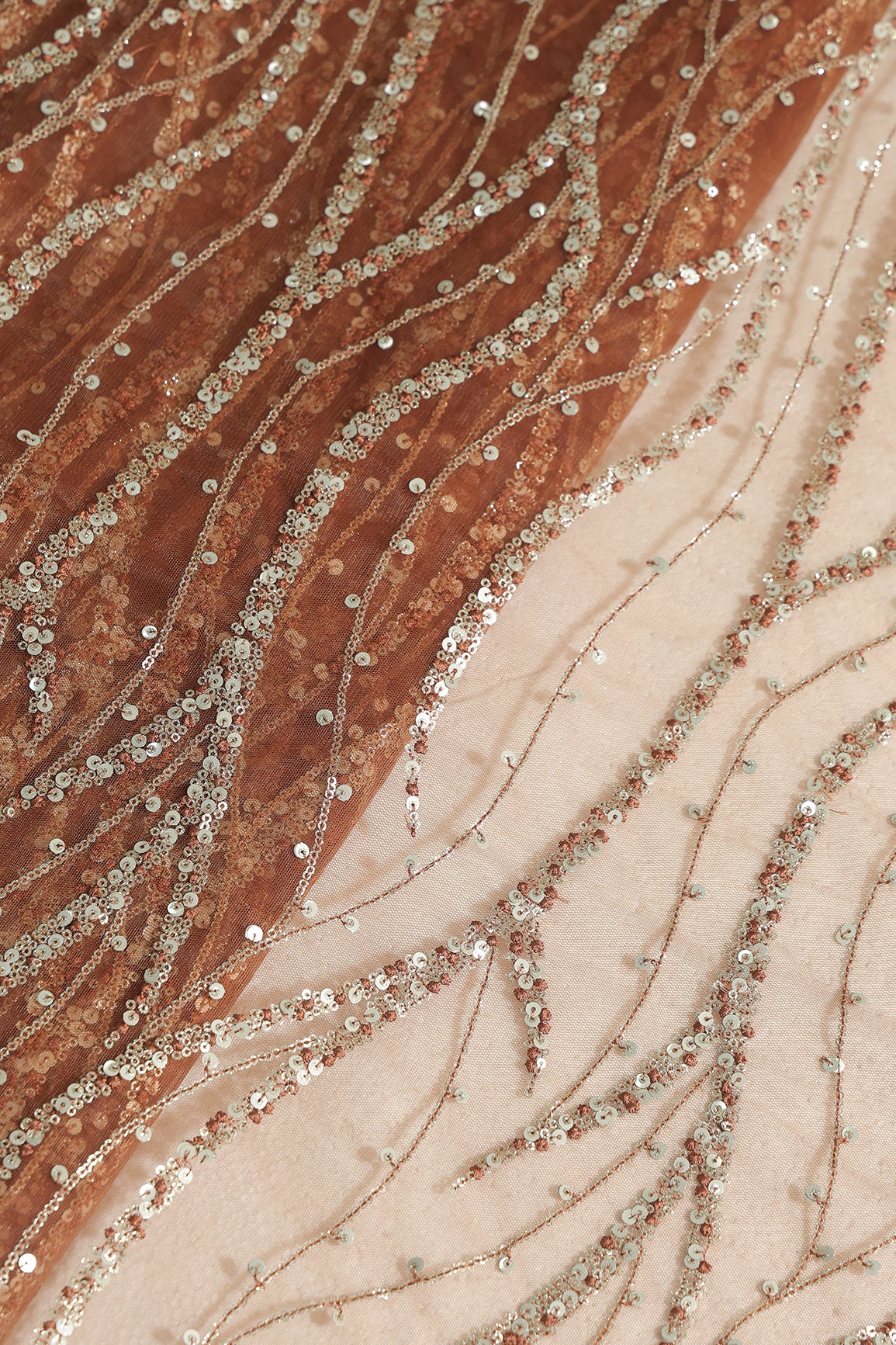 Gold And Silver Sequins With Brown Thread Wavy Embroidery Work On Brown Soft Net Fabric