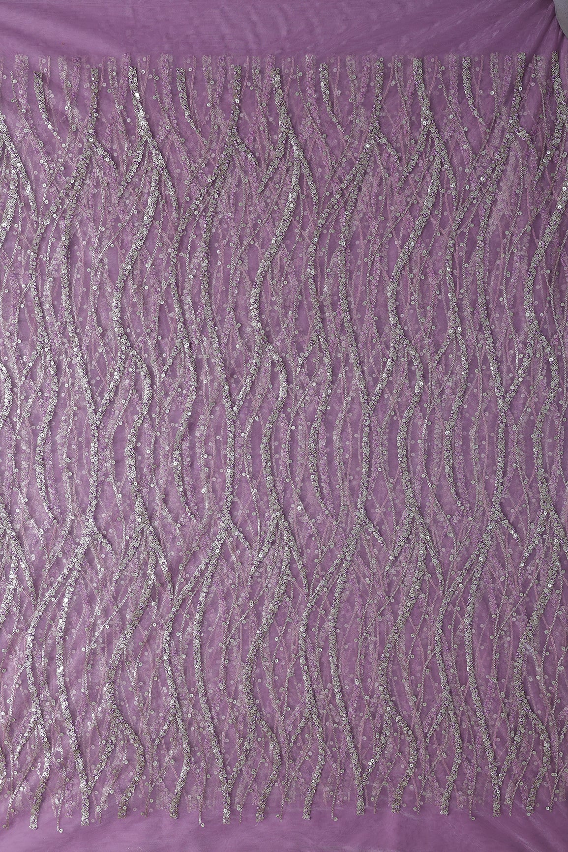 Gold And Silver Sequins With Lavender Thread Wavy Embroidery Work On Lavender Soft Net Fabric