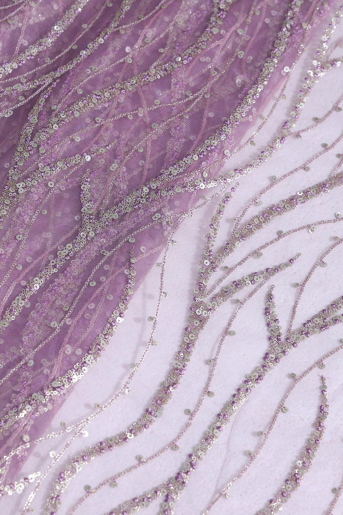 Gold And Silver Sequins With Lavender Thread Wavy Embroidery Work On Lavender Soft Net Fabric