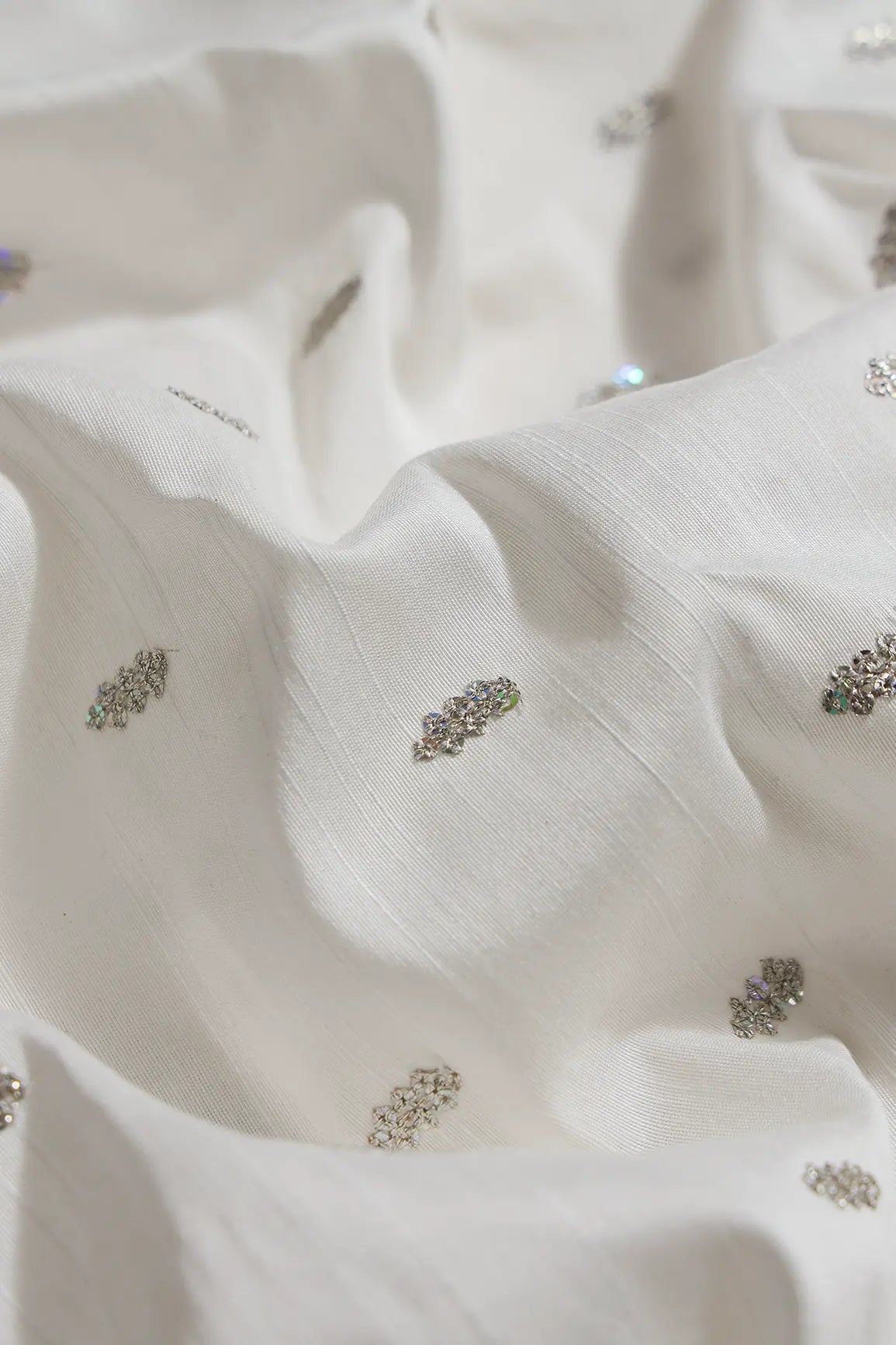 Silver Sequins With Gold Zari Small Motif Embroidery Work On White Raw Silk Fabric