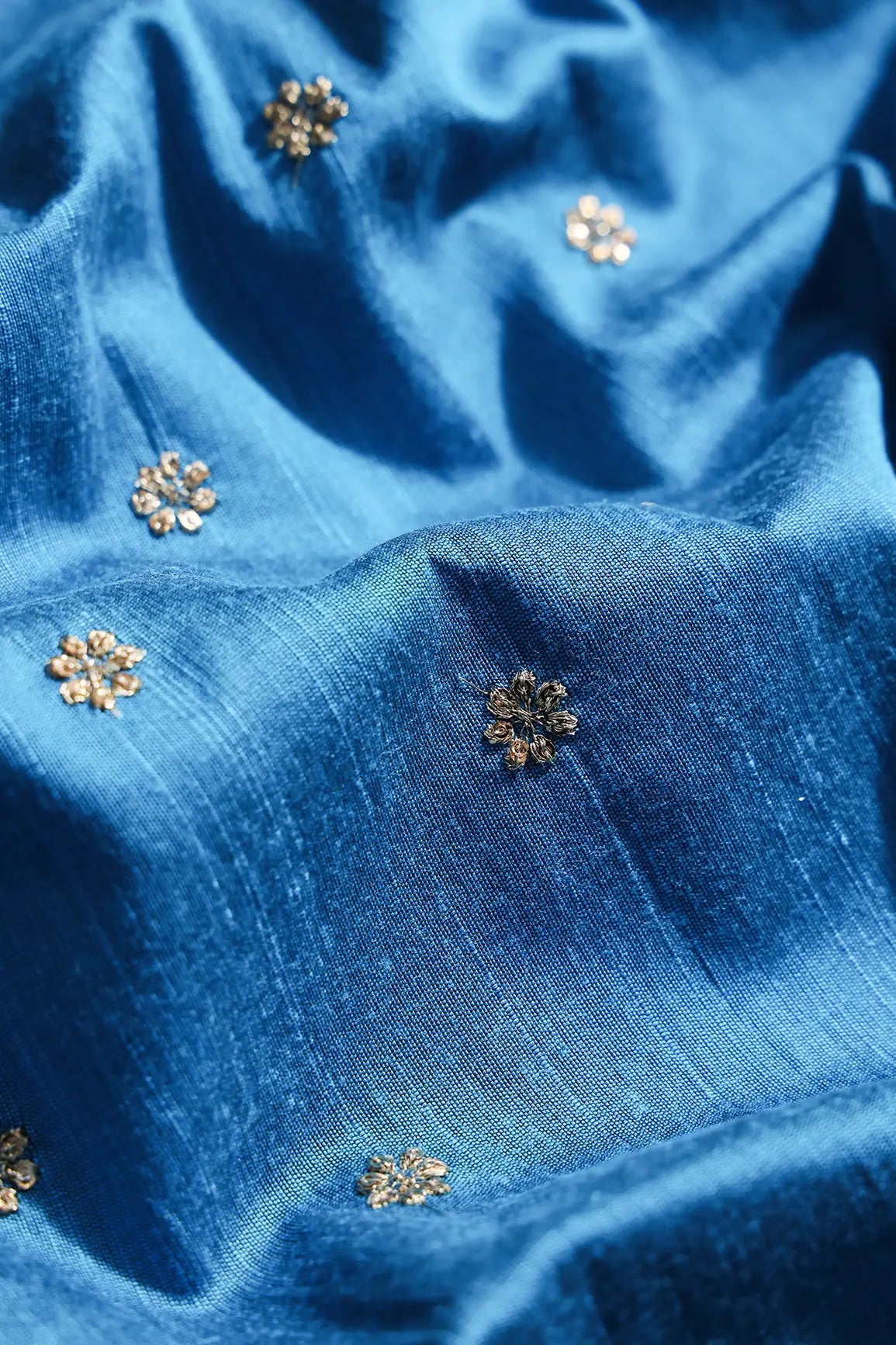 Gold Sequins With Gold Zari Small Motif Embroidery Work On Rama Blue Raw Silk Fabric