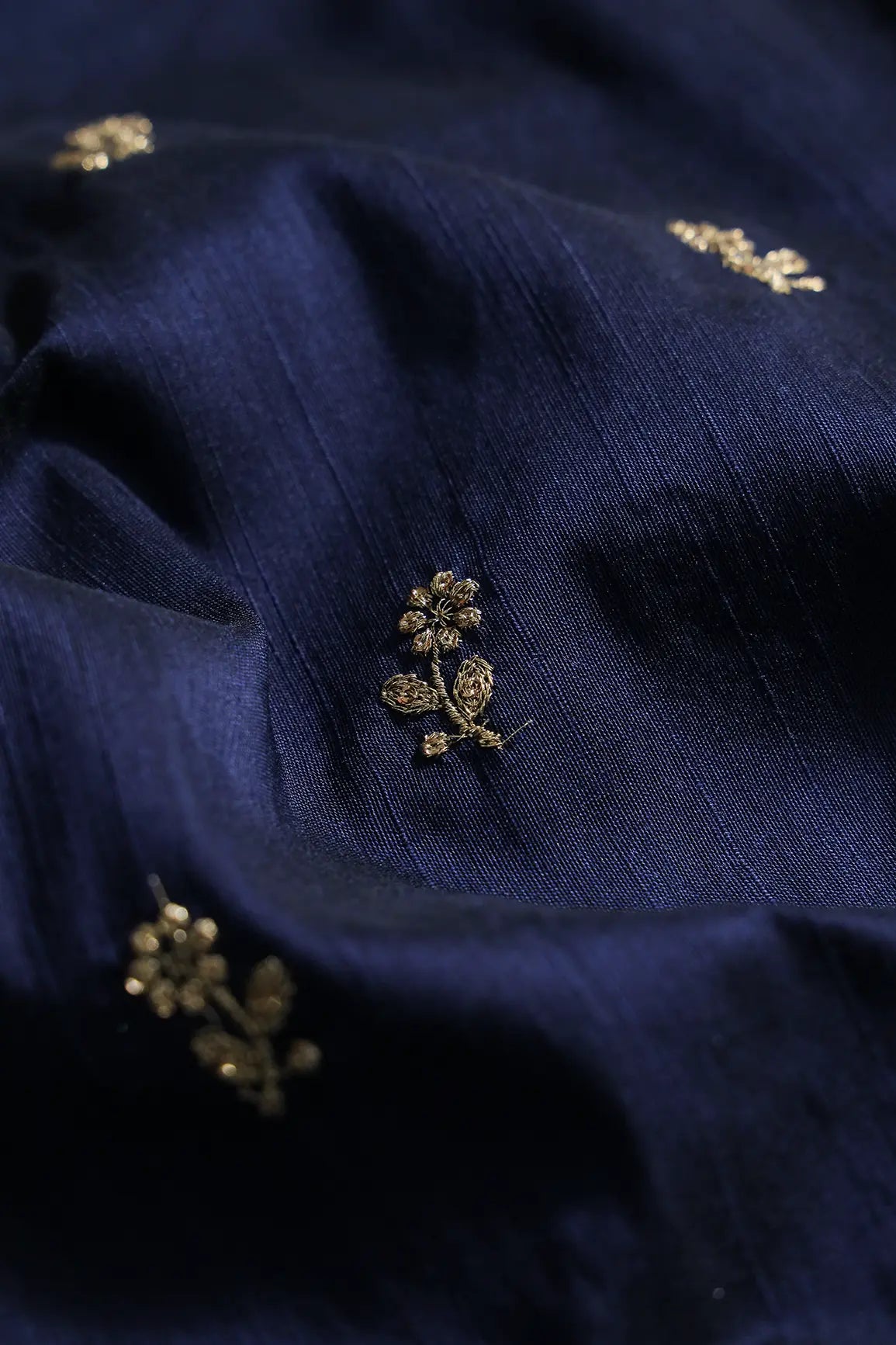 Gold Sequins With Gold Zari Small Floral Motif Embroidery Work On Navy Blue Raw Silk Fabric