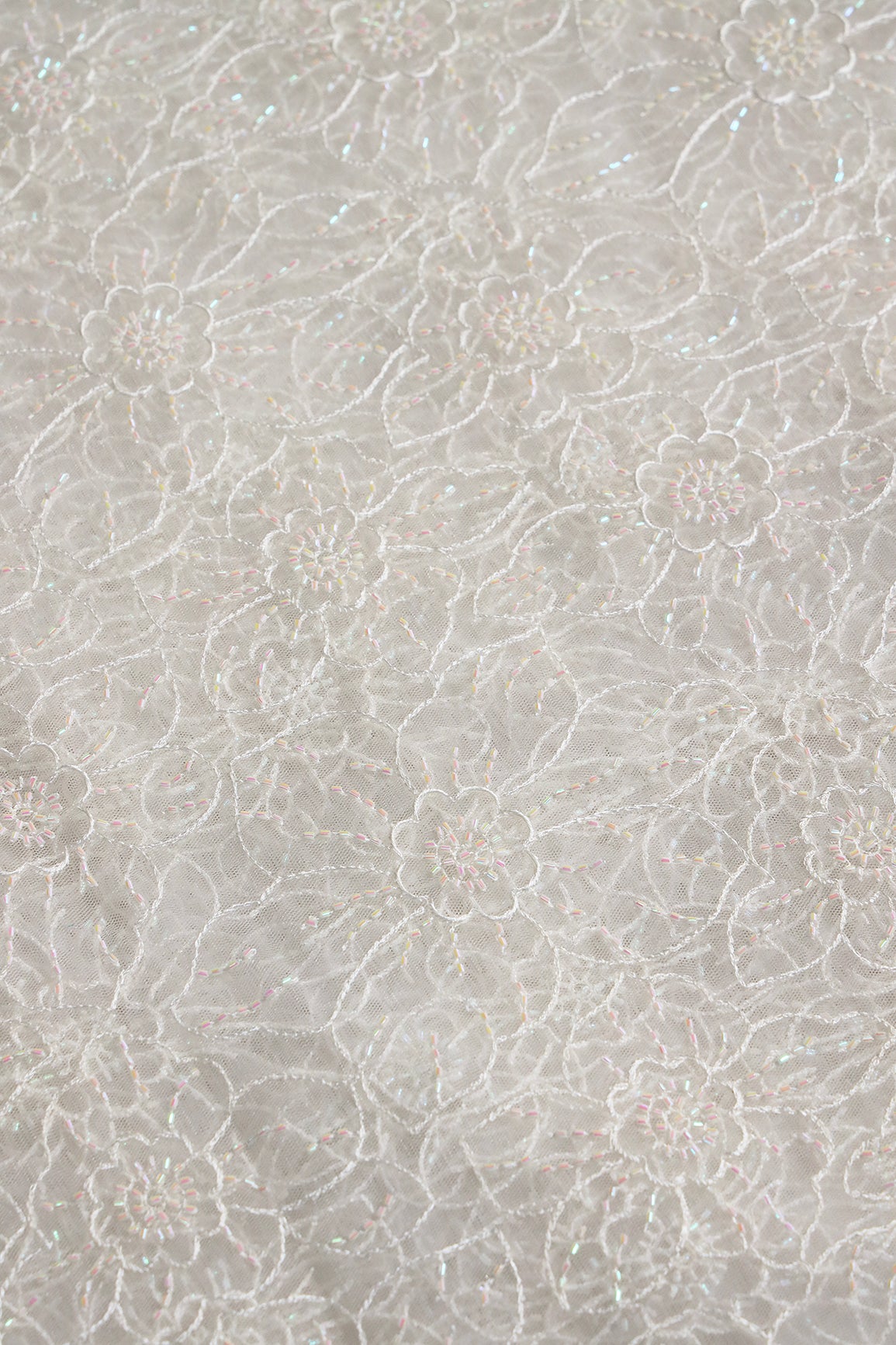 White Thread With Beads Floral Embroidery Work On White Dyeable Soft Net Fabric
