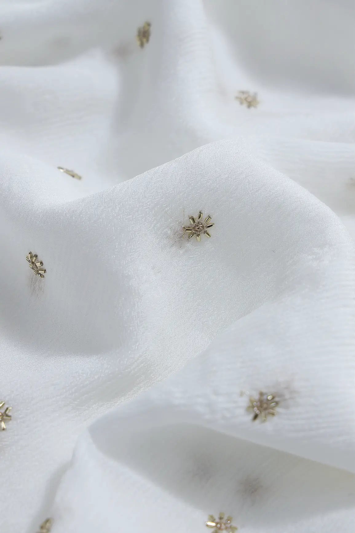 Gold Beads Cut Dana Motif Embroidery Work On White Dyeable Chinnon Chiffon Fabric