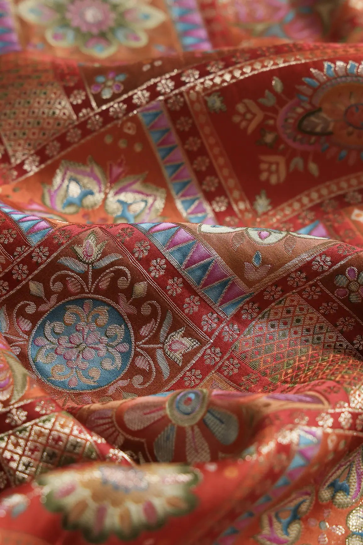 Positional Floral Zari Print On Orange Viscose Dola Silk Jacquard Fabric